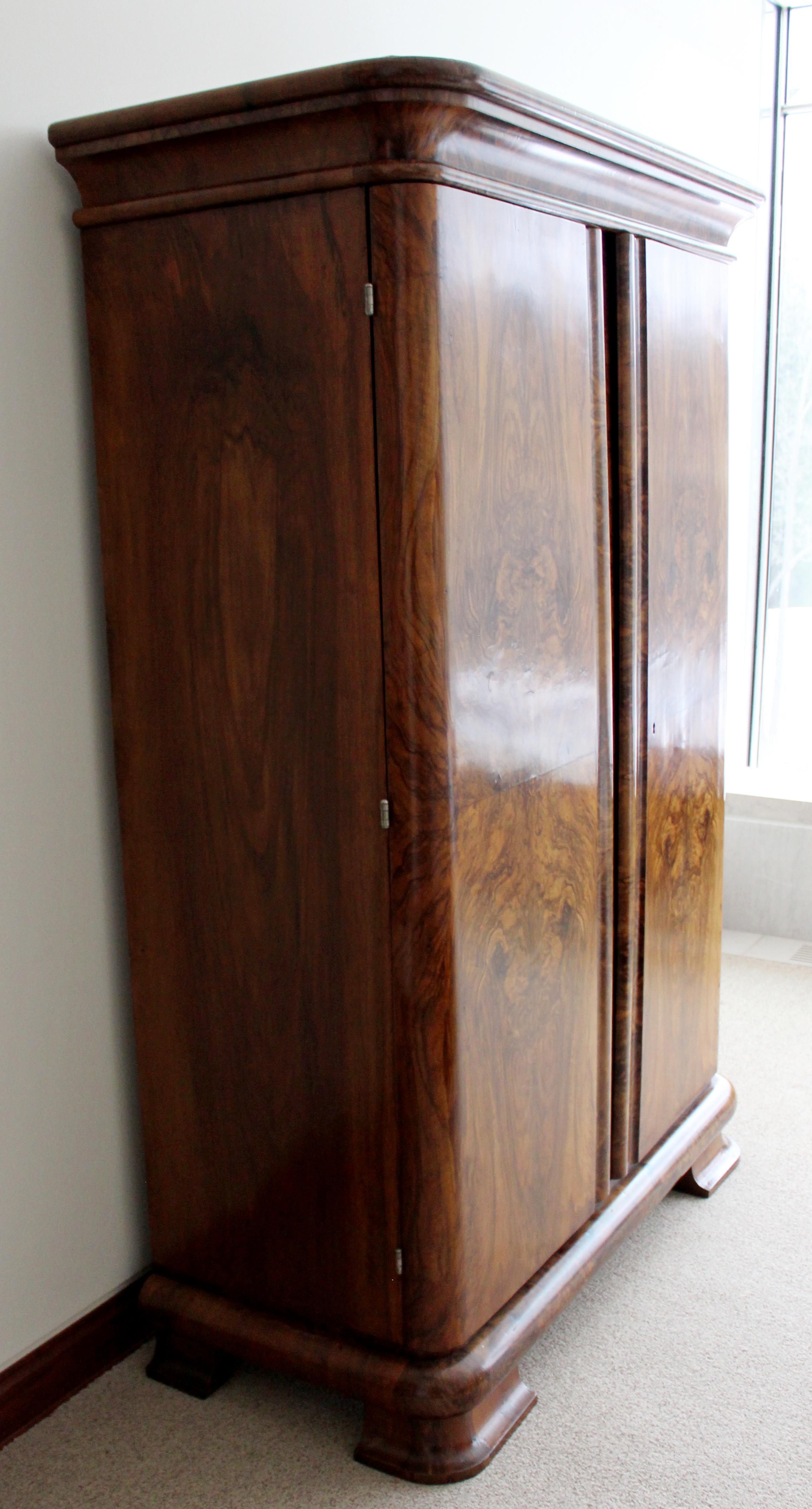 For your consideration is a beautiful, vintage tall, burl wood bookmatched panel cabinet armoire wardrobe unit, circa 1940s. In very good vintage condition. The dimensions are 51