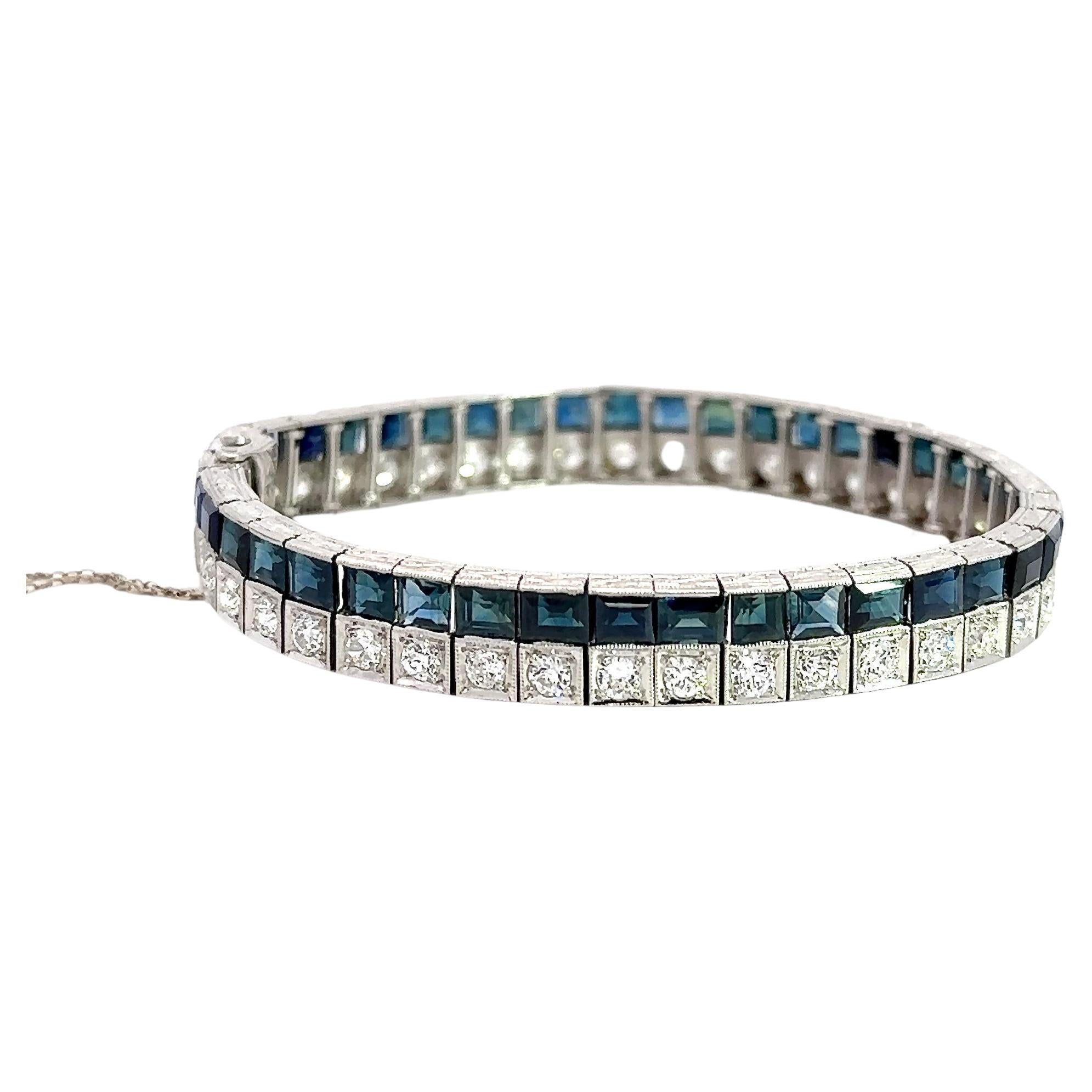 This Art Deco diamond and blue sapphire line bracelet dates from the 1930's. It contains 42 old European-cut diamonds that weigh approximately 4.5CT, H-I Color, VS-SI Clarity. It also contains 42 baguette-cut natural sapphires that weigh
