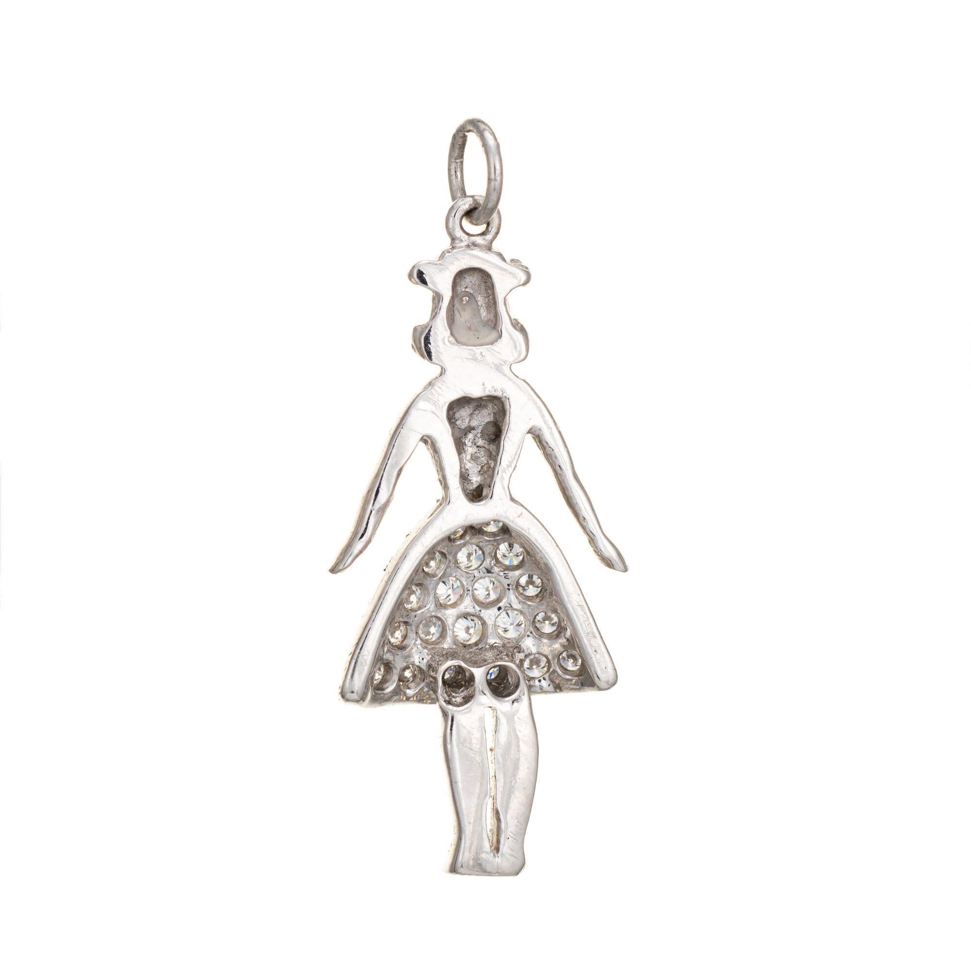 Finely detailed vintage Art Deco era charm crafted in 900 platinum (circa 1920s to 1930s).  

20 round brilliant cut diamonds total an estimated 0.10 carats (estimated at H-I color and VS2-SI1 clarity).

The sweet and petite charm depicts a woman
