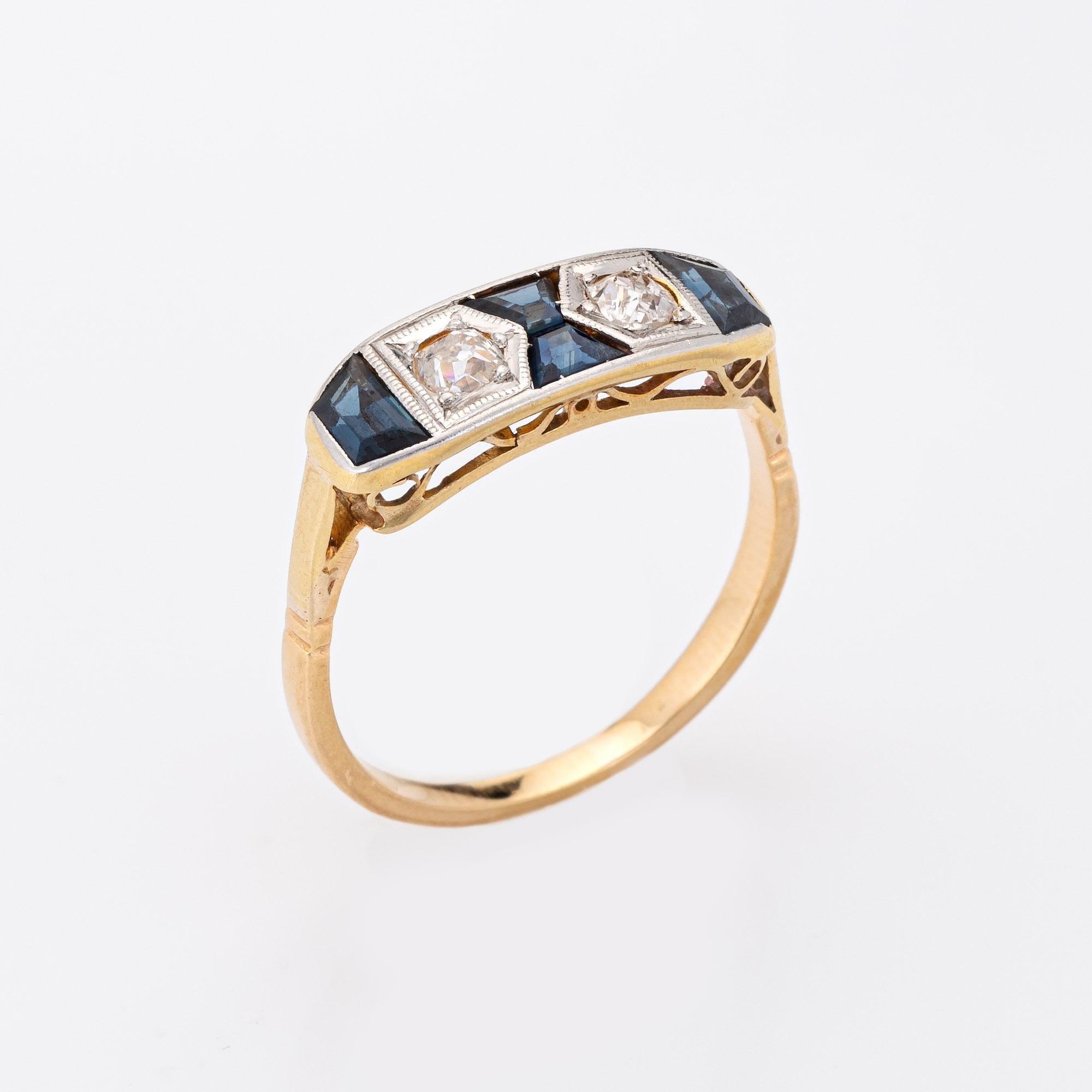 Finely detailed vintage Art Deco diamond & sapphire ring (circa 1920s to 1930s) crafted in 18k yellow gold & platinum. 

Two estimated 0.10 carat old mine cut diamonds total an estimated 0.20 carats (estimated at J-K color and SI1-2 clarity). Four