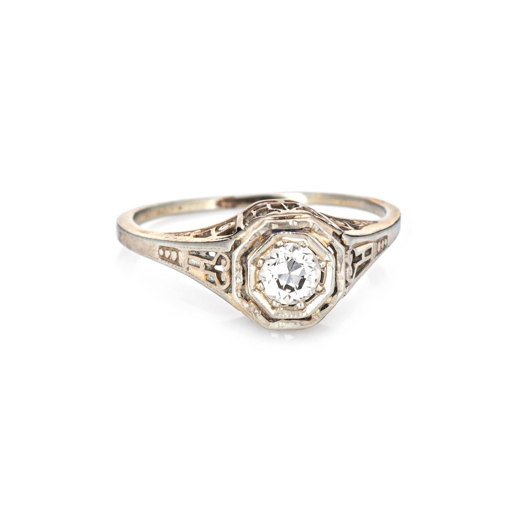 Finely detailed vintage Art Deco diamond engagement ring (circa 1920s to 1930s) crafted in 18 karat white gold. 

One old European cut diamond is estimated at 0.20 carats (estimated at H-I color and VS2 clarity). 

The old European cut diamond is