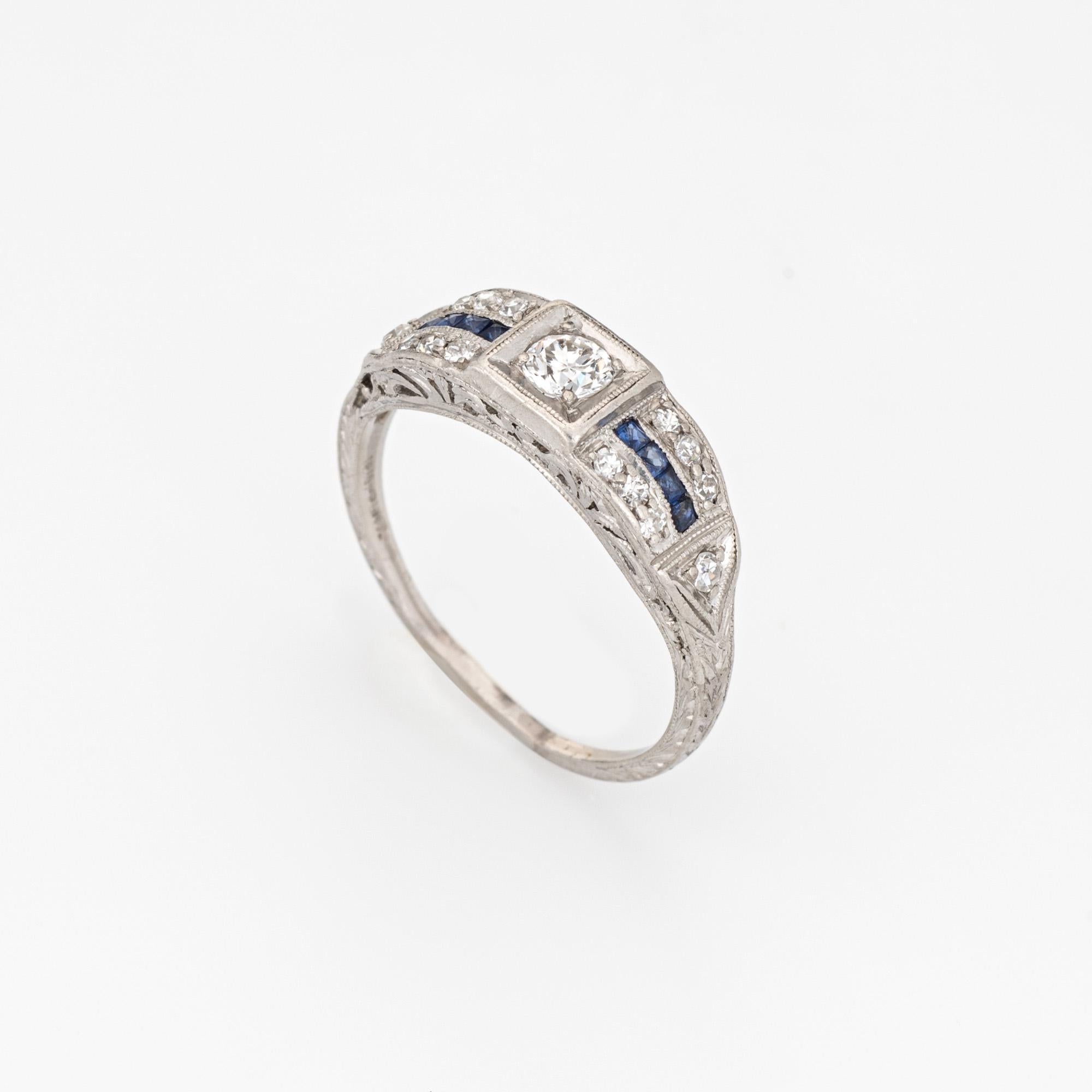Finely detailed vintage Art Deco diamond & sapphire ring (circa 1920s to 1930s) crafted in platinum. 

Center set estimated 0.20 carat old European cut diamond is accented with 14 estimated 0.02 carat single cut diamonds. The total diamond weight is
