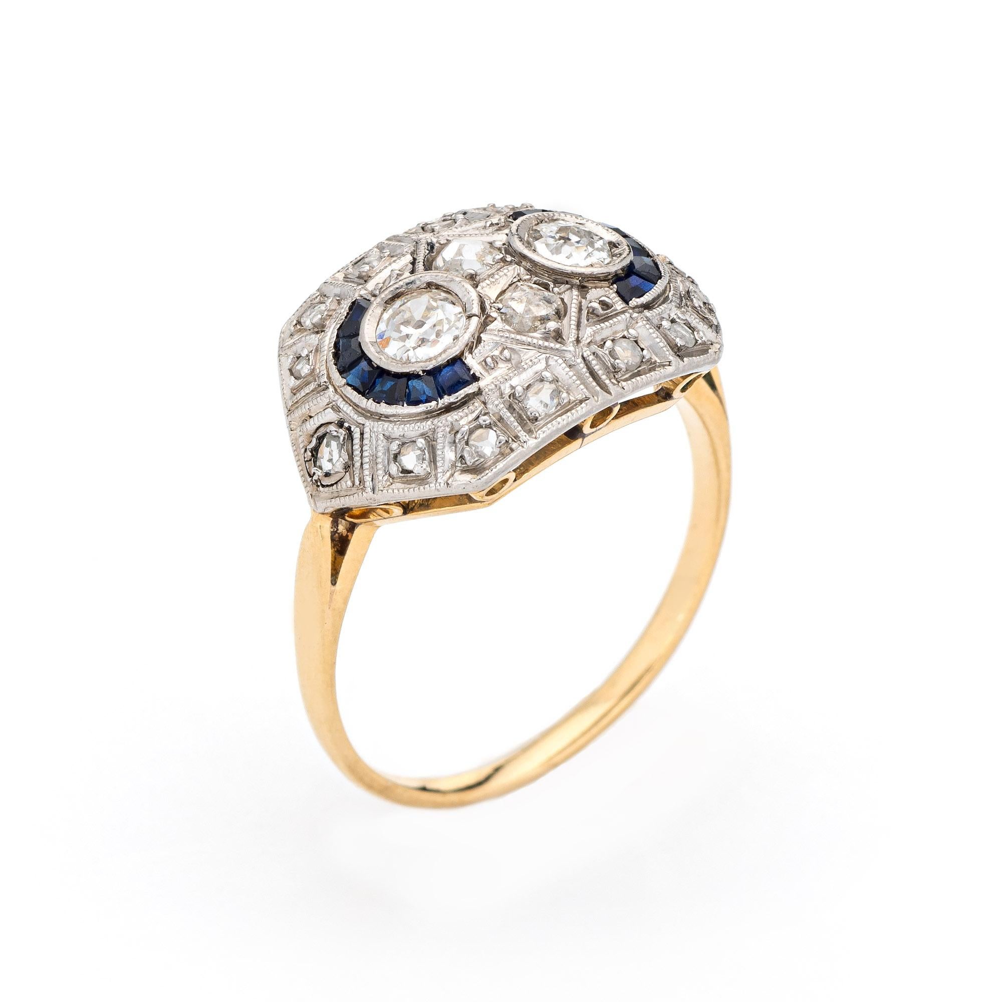 Finely detailed vintage Art Deco diamond & sapphire ring (circa 1920s to 1930s) crafted in 18k yellow gold & platinum. 

Two center set estimated 0.15 carat old mine cut diamonds total an estimated 0.30 carats (estimated at J-K color and SI1-I1