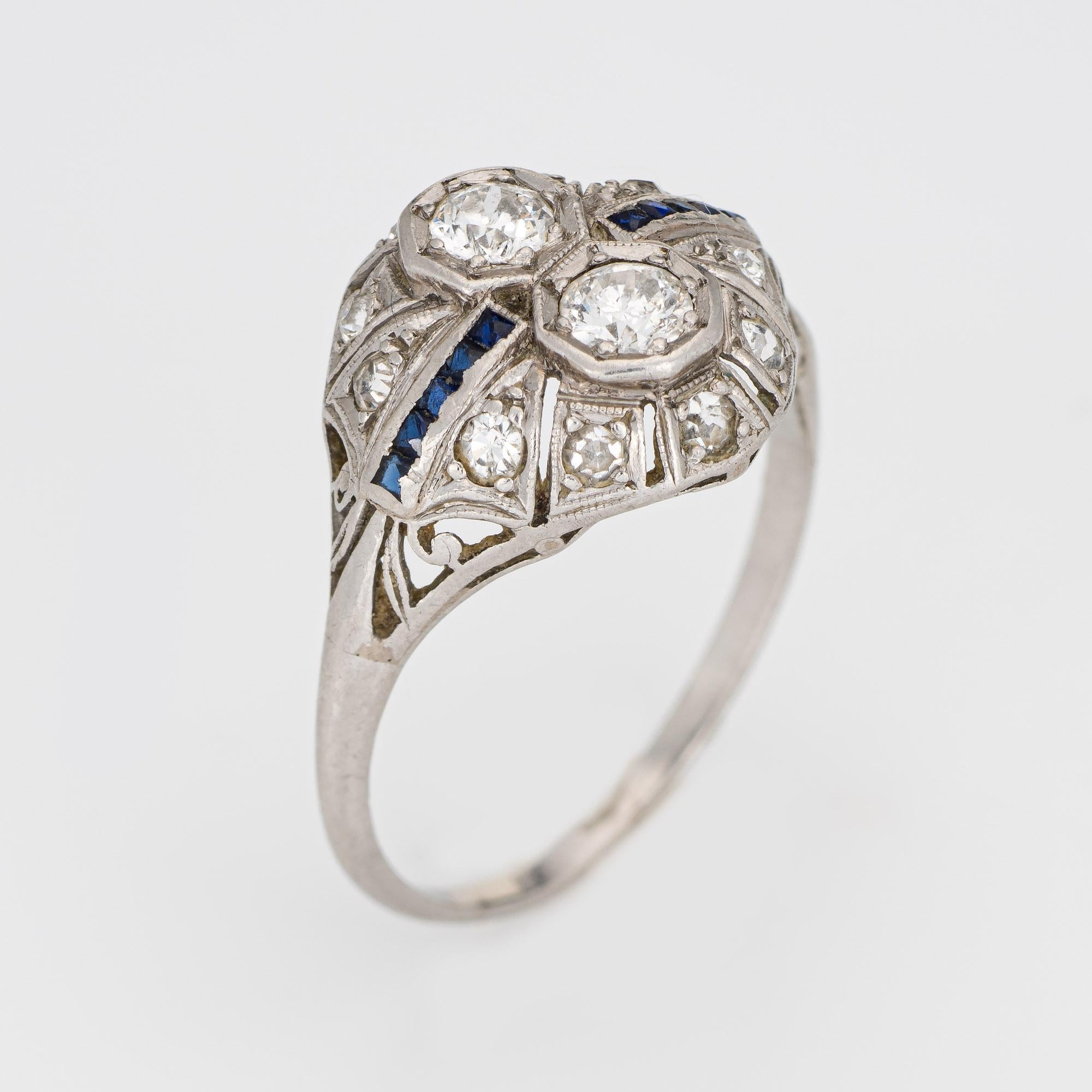 Elegant & finely detailed Art Deco era ring (circa 1920s to 1930s) crafted in 900 platinum. 

Two centrally mounted estimated 0.25 carat old European cut diamonds are accented with a further 10 estimated 0.01 carat old single cut diamonds. The total