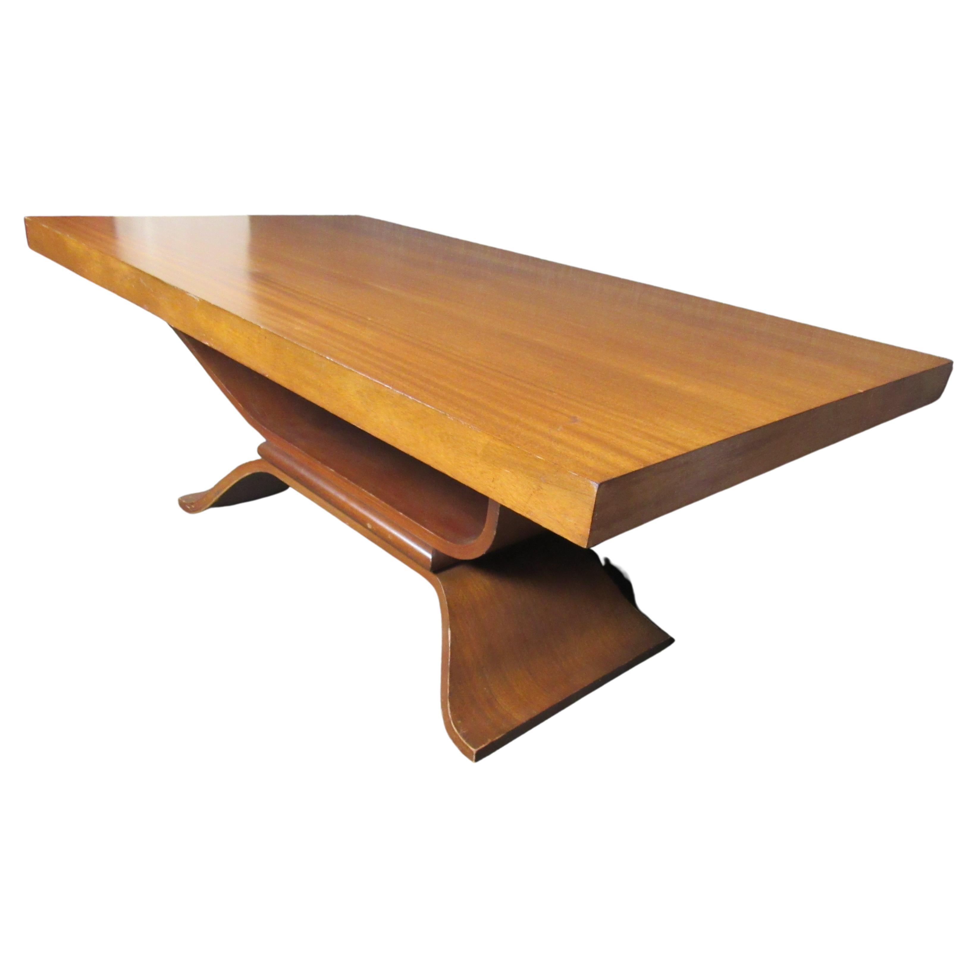 A stunning art deco style mahogany table, sure to impress your guests for years to come. A large tabletop provides plenty of room for anything from dinner parties to board meetings. An attractive contrasting bentwood base provides ample sturdiness.
