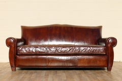 Vintage Art Deco Distressed Brown Leather Three-Seat Sofa With Mustache Back