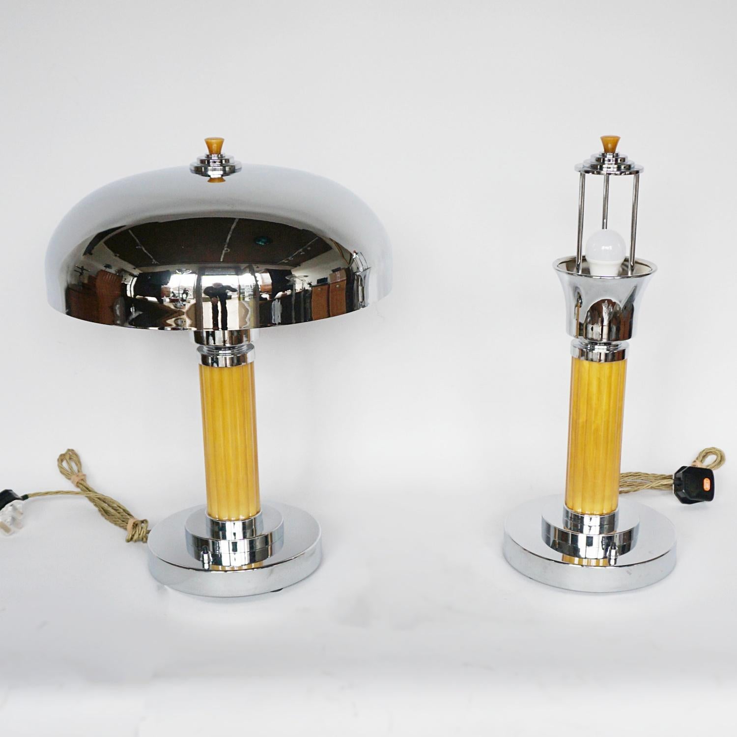 A pair of Art Deco dome lamps. Thick, reeded yellow bakelite stem over a stepped circular base with a chromed metal dome shade. Bakelite finial to top. 

Dimensions: H 50cm D 36cm 

Origin: English

Item Number: 1003221

All of our lighting