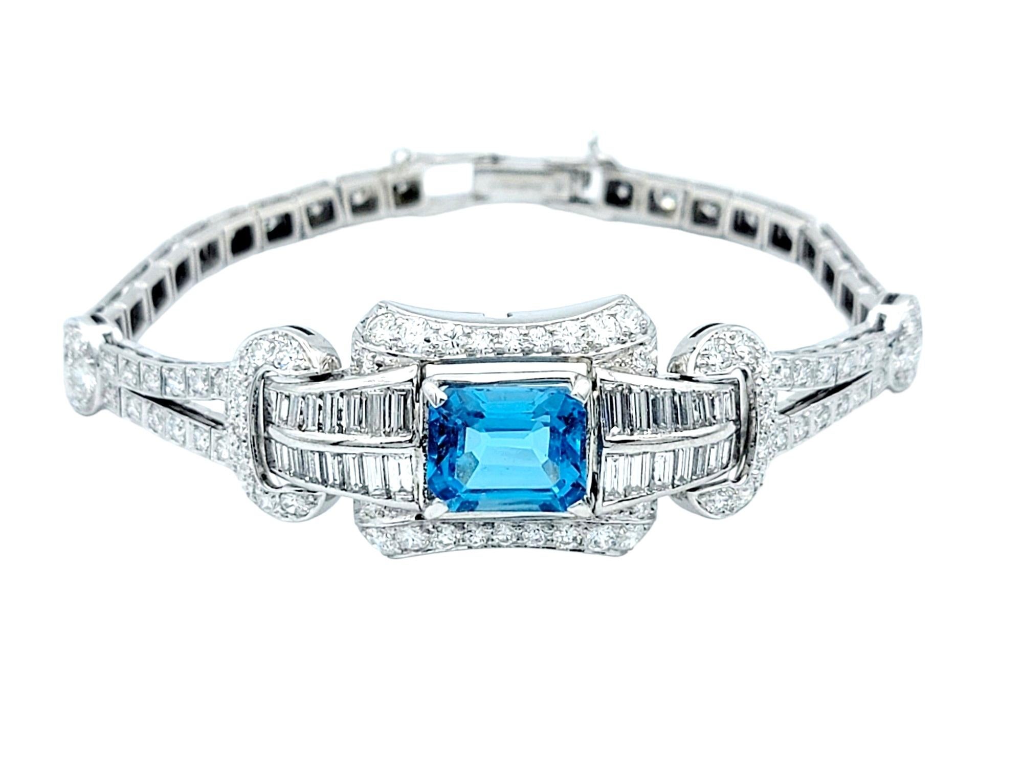 A timeless masterpiece from the Art Deco era, this exquisite vintage bracelet exudes elegance and sophistication. Crafted in lustrous polished platinum, the enchanting blue stone paired with the dazzling diamonds makes this a piece you won't be able