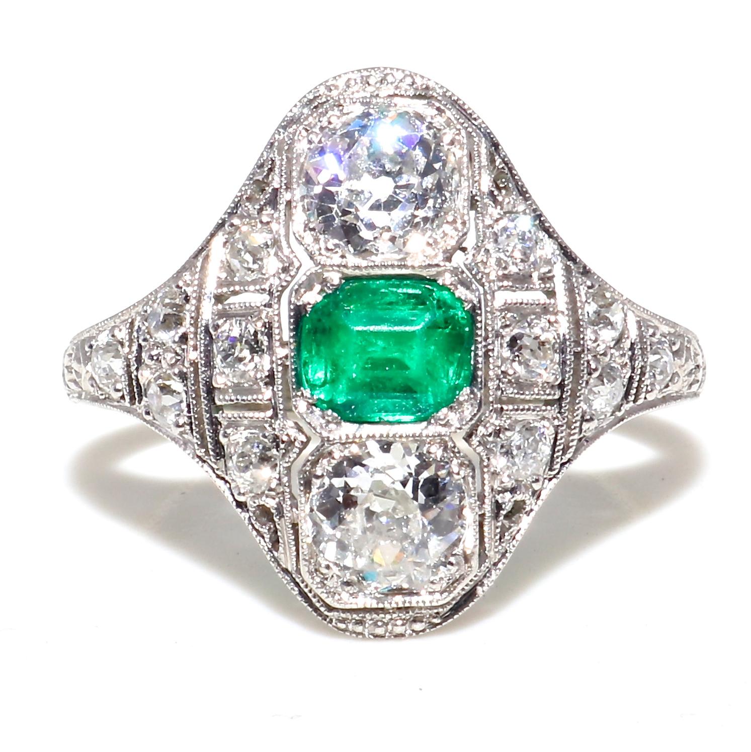Stunning Art Deco emerald diamond platinum ring. Featuring an approximately 0.50 carat emerald cut emerald and 2 old European cut diamonds that weigh approximately 0.40 carats each, graded F-G color, SI clarity. With 12 old European cut diamonds