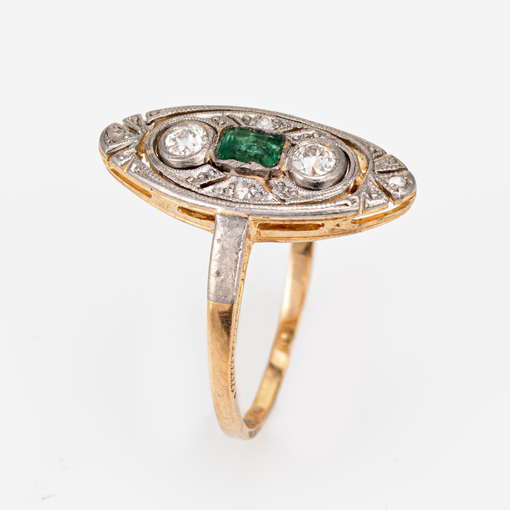 Finely detailed vintage Art Deco diamond & emerald ring (circa 1920s to 1930s) crafted in 14k yellow & white gold. 

Two center set estimated 0.10 carat old mine cut diamonds total an estimated 0.20 carats (estimated at J-K color and SI1-I1