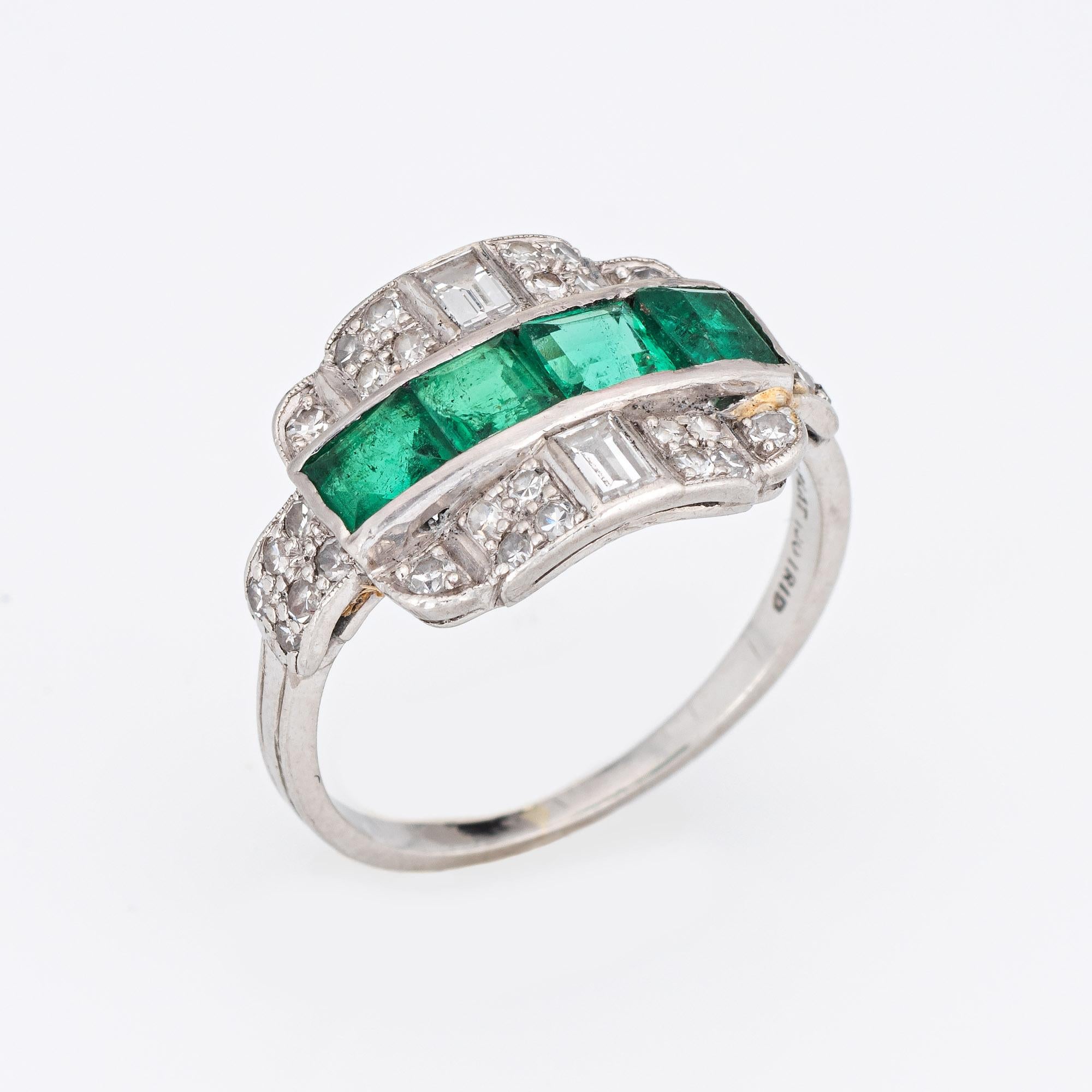 Finely detailed vintage Art Deco emerald 7 diamond ring (circa 1920s to 1930s) crafted in platinum. 

Four emeralds are estimated at 0.20 carats each (0.80 carats total estimated weight). Two square cut diamonds are estimated at 0.10 carats each,