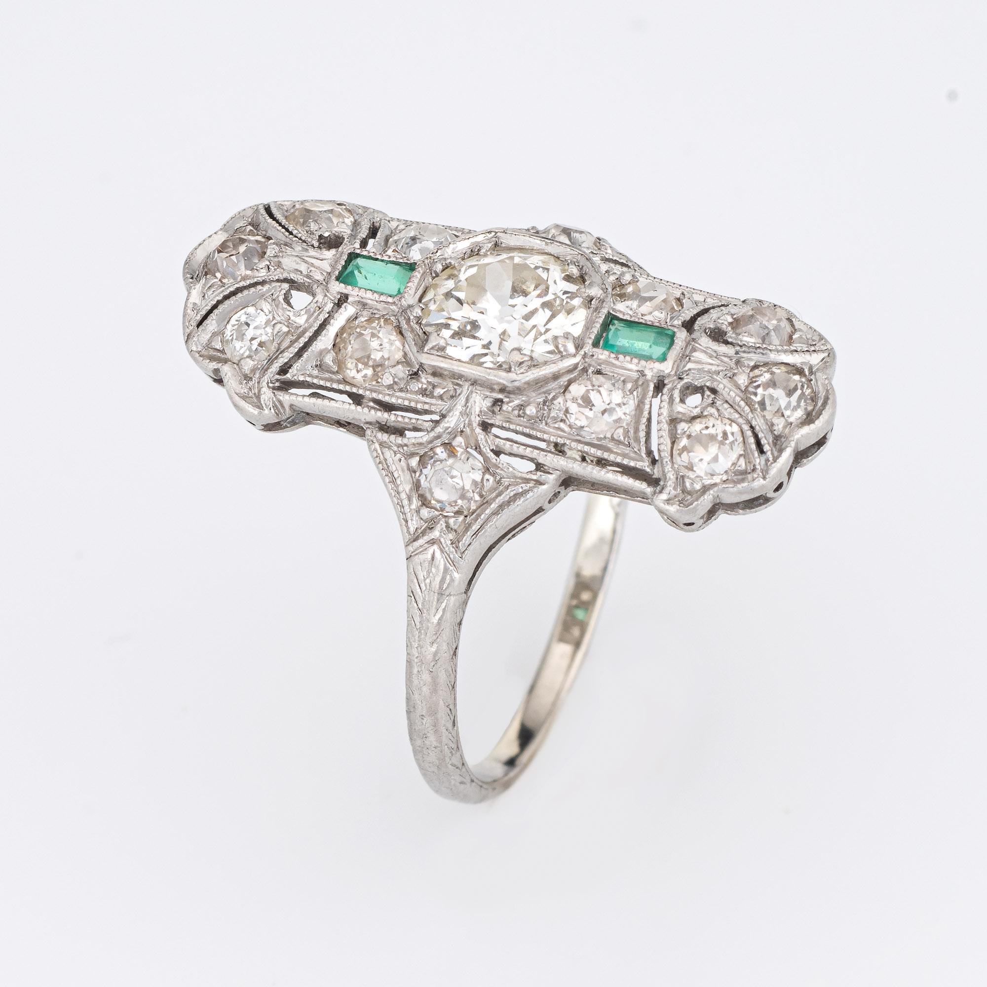 Finely detailed vintage Art Deco emerald & diamond ring (circa 1920s to 1930s) crafted in platinum. 

Center set old European cut diamond is estimated at .90 carats, accented with 12 estimated 0.05 carat old mine cut diamonds. The total diamond