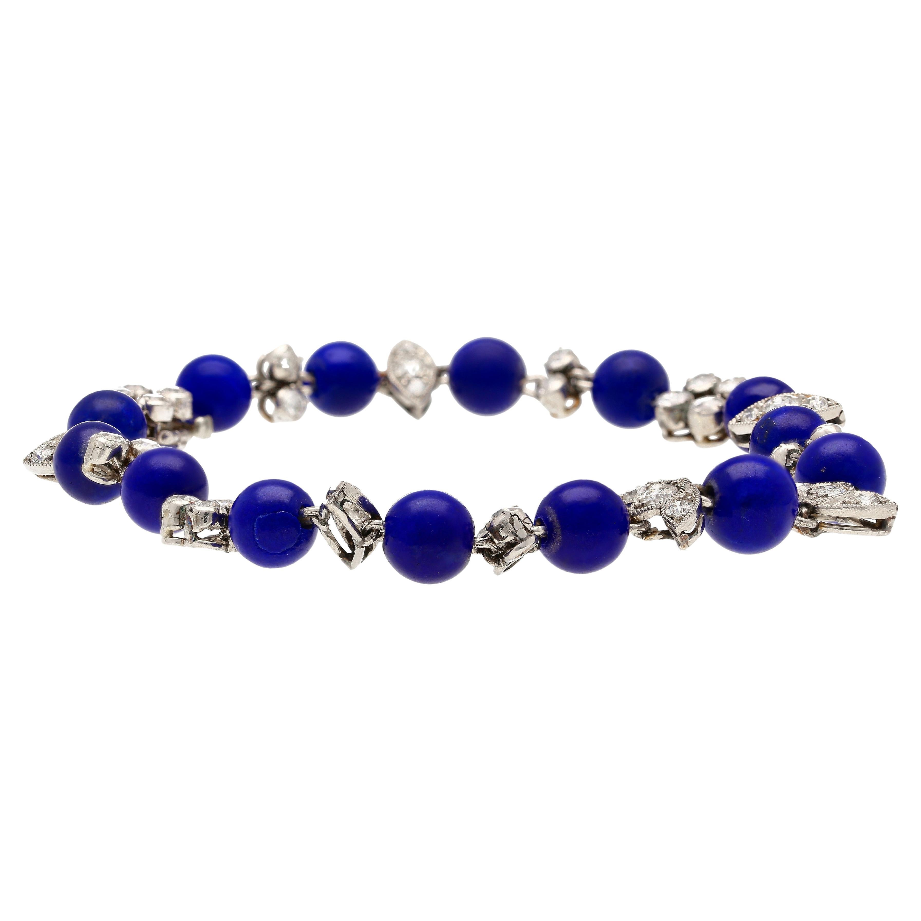 Vintage Art Deco era Blue Lapis and Diamond floral motif link bracelet. Set with 14 Lapis Lazuli beads and 40 round-cut diamonds. This piece is an original Art Deco era bracelet. Circa 1930-40.

Lapis has been prized by antiquities for its intense