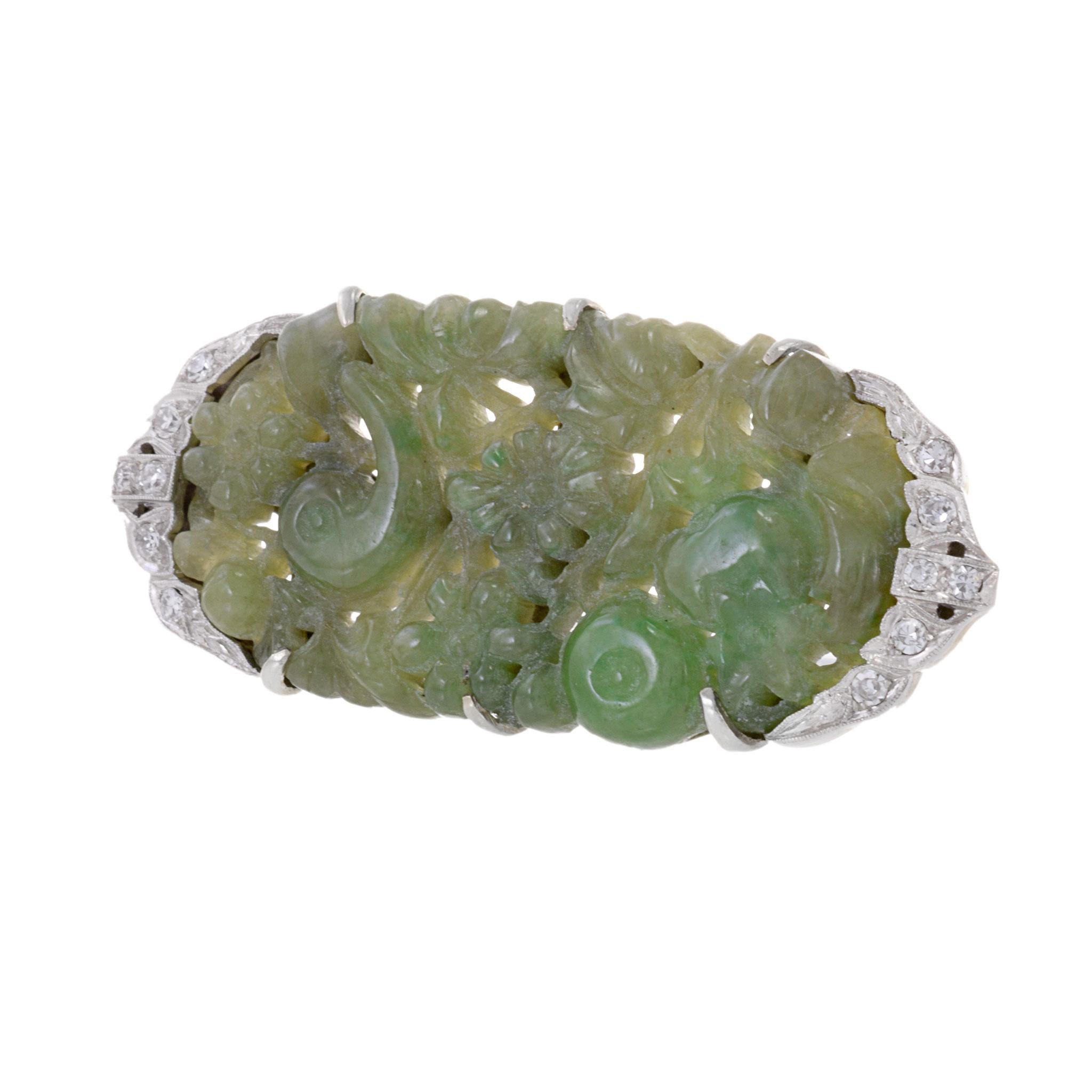 Crafted from high-quality platinum and 18KT white gold, this vintage art deco era brooch features genuine jade and sparkling .30ct-tw F-VS/SI diamonds. A timeless and elegant piece that exudes sophistication and luxury. Elevate your style with this