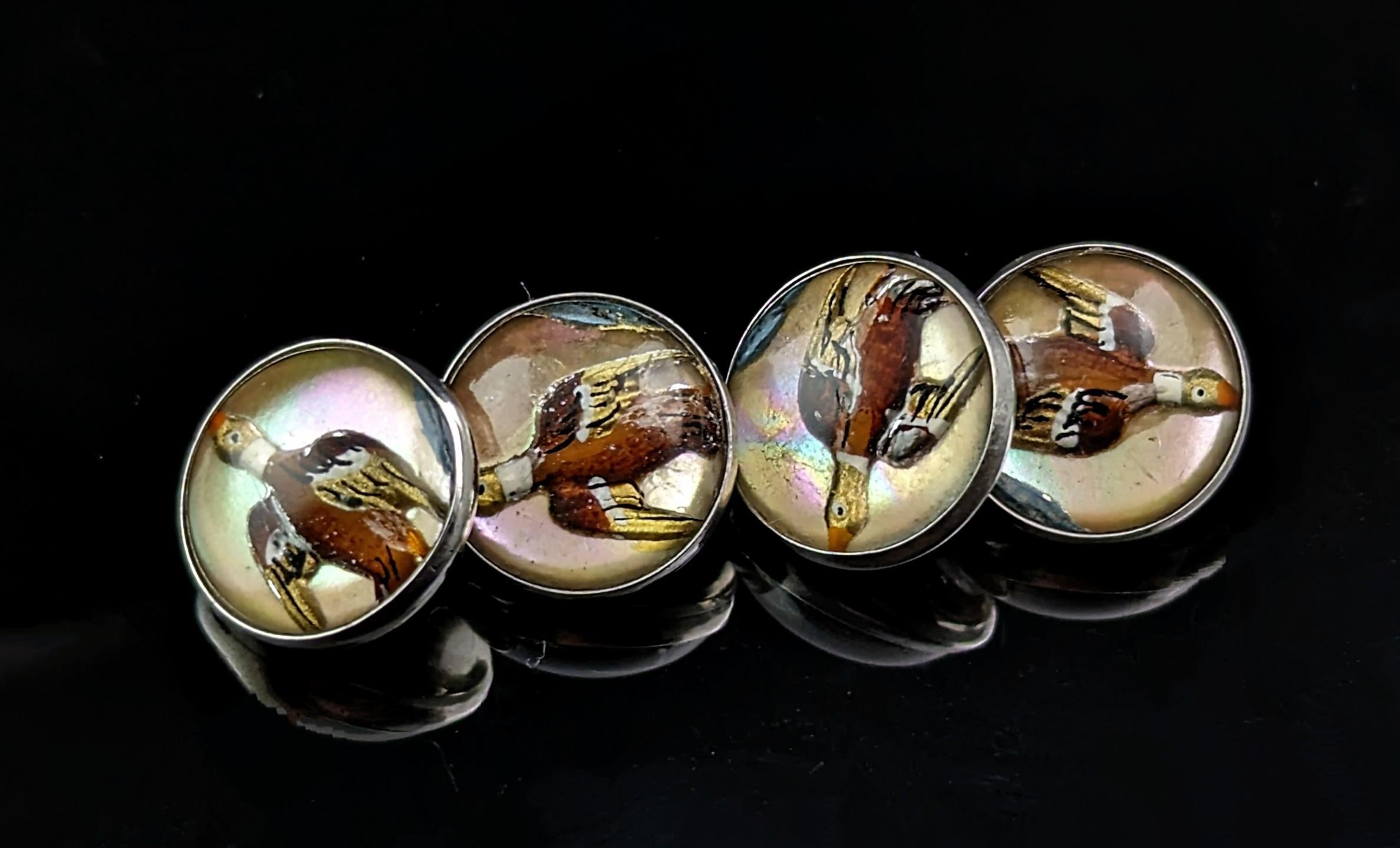 You can't go wrong with a good pair of fun vintage cufflinks and that's exactly what these are.

Modelled in sterling silver these Aer Deco era cufflinks feature reverse painted rock crystal cabochons or Essex crystal as it is known.

These