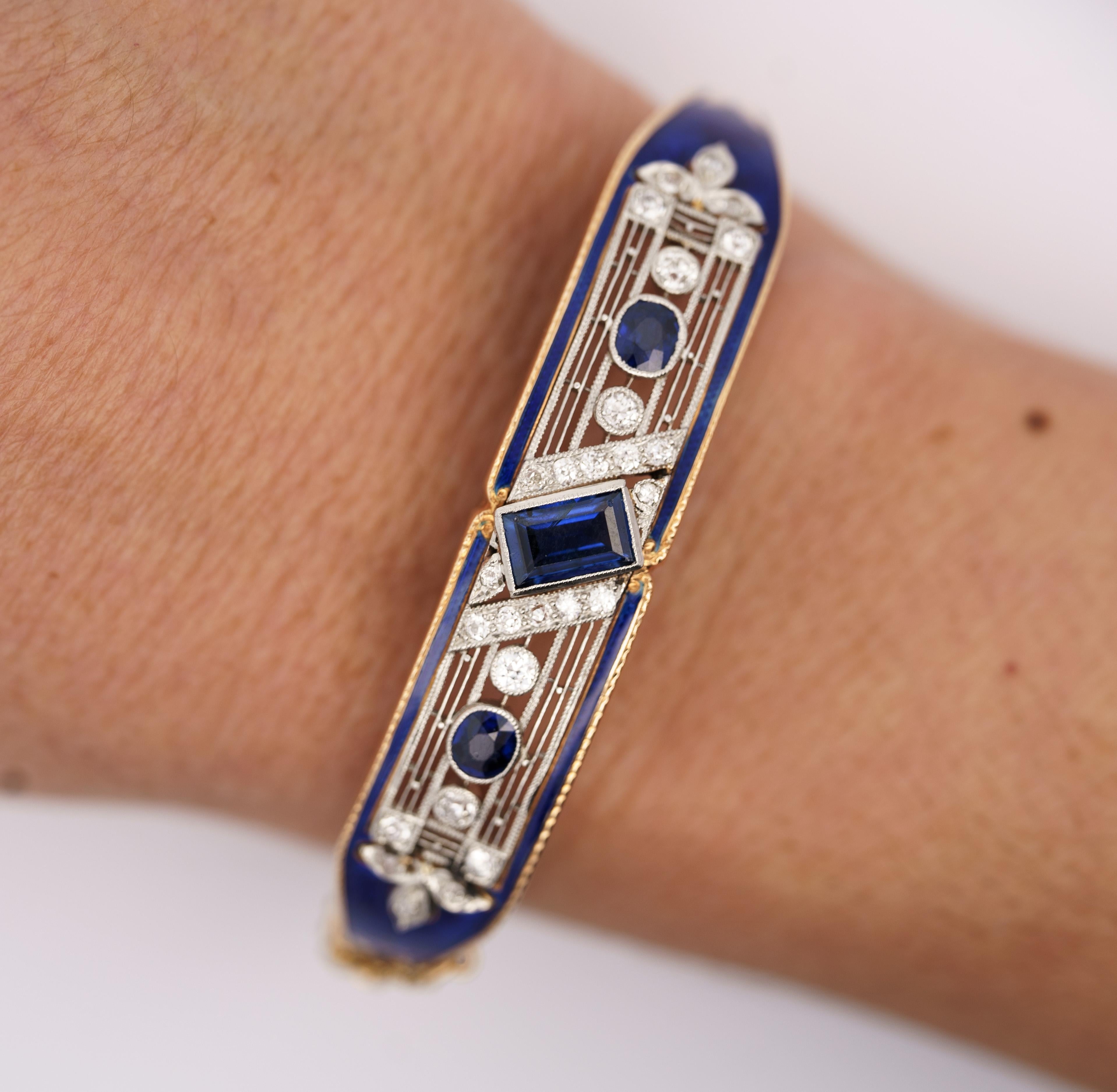 Vintage Art Deco EGL Certified 2.08 carat total natural Blue Sapphire, Diamond, and Blue Enamel bangle bracelet. 

This bangle features a 1.15 carat natural blue sapphire center stone. The sapphire is emerald step-cut, and EGL-certified. It is