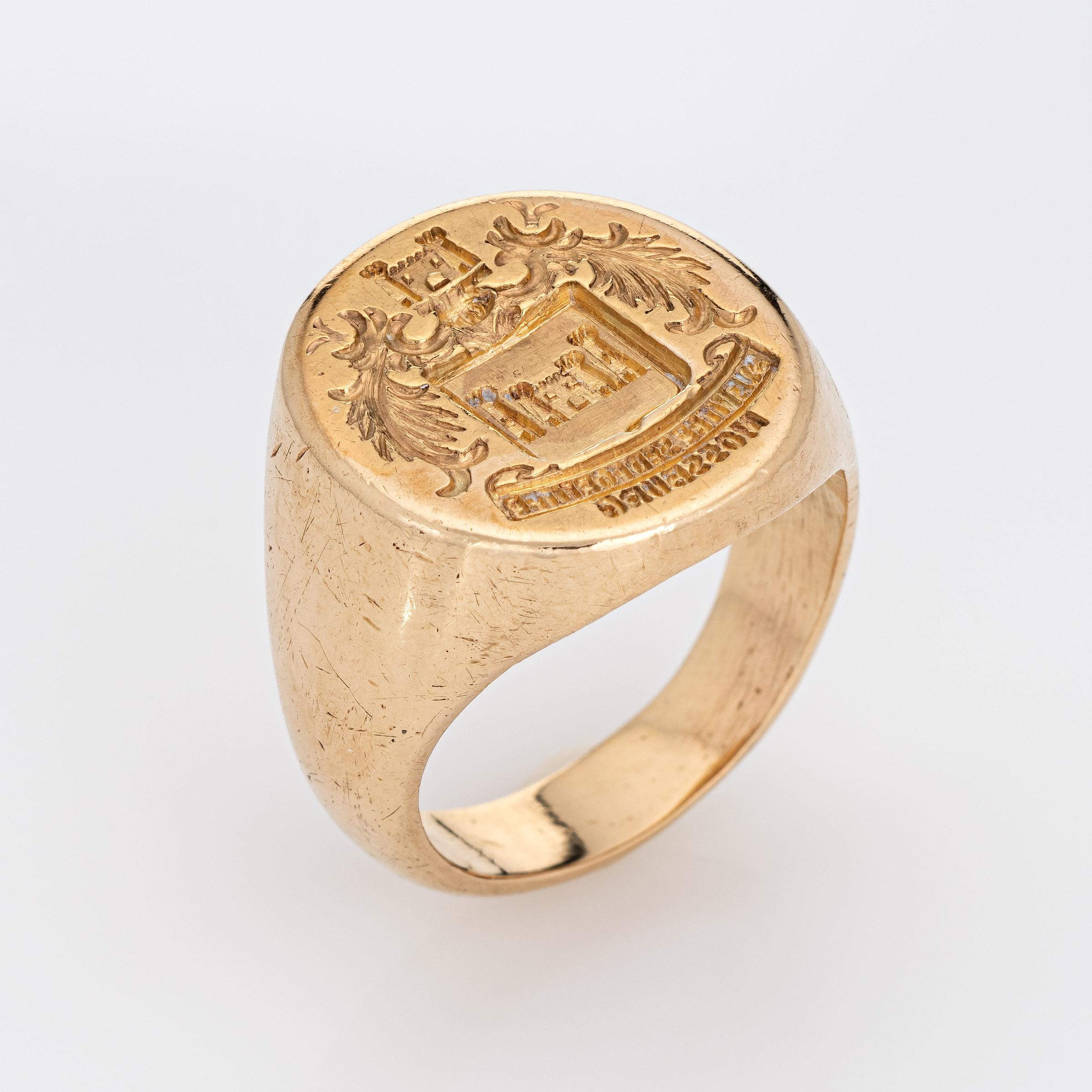 Finely detailed vintage Art Deco era family crest signet ring (circa 1920s to 1930s) crafted in 14 karat yellow gold. 

The signet ring weighs a hefty 18.7 grams. The signet mount features a castle framed with wreaths to the sides. The base of the