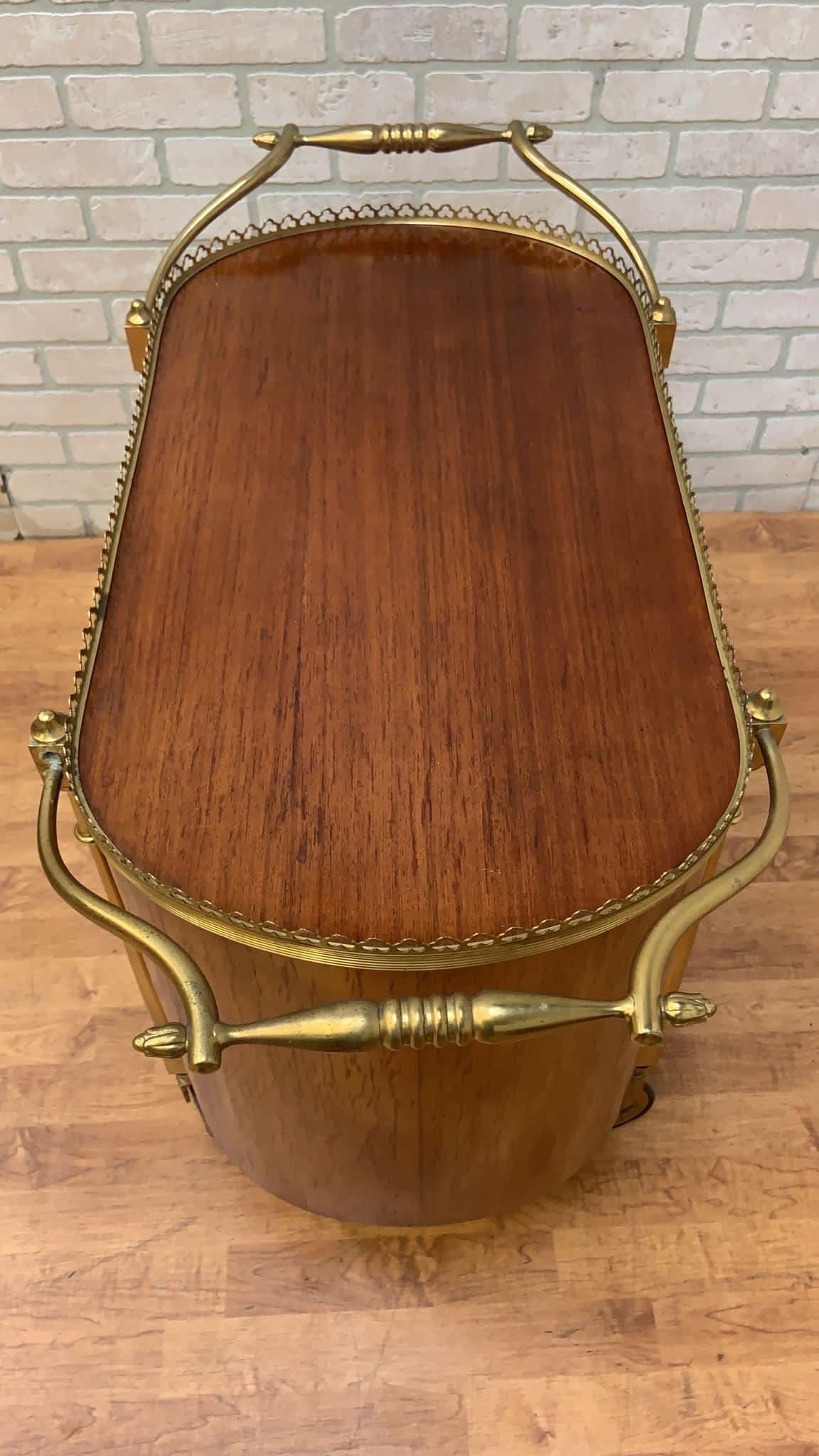 Vintage French Art Deco Style Brass & Wood Bar Cart

Beautiful Art deco wood and brass rolling bar cart. Oval top with all around brass gallery and 2 handles. The cabinet has brass bottle holders. 

Circa Mid 20th Century 

Dimensions 

W 34”
D