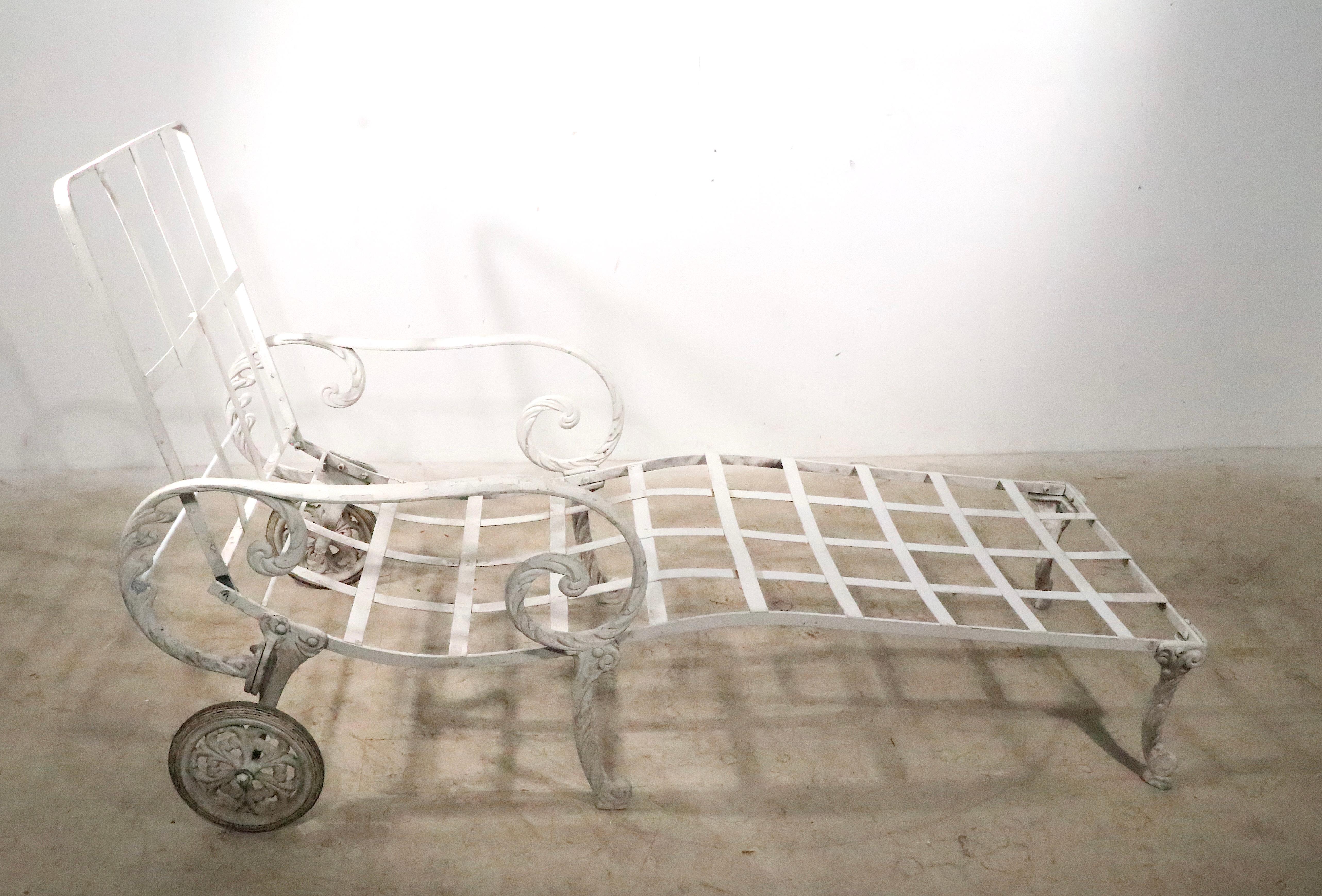 Sophisticated, voguish, Art Deco, Hollywood Regency style garden, patio, poolside chaise lounge attributed to Molla c 1930's. The arms are of stylized cast aluminum, the back is adjustable in height ( H position 34.5 in. ) The piece is structurally