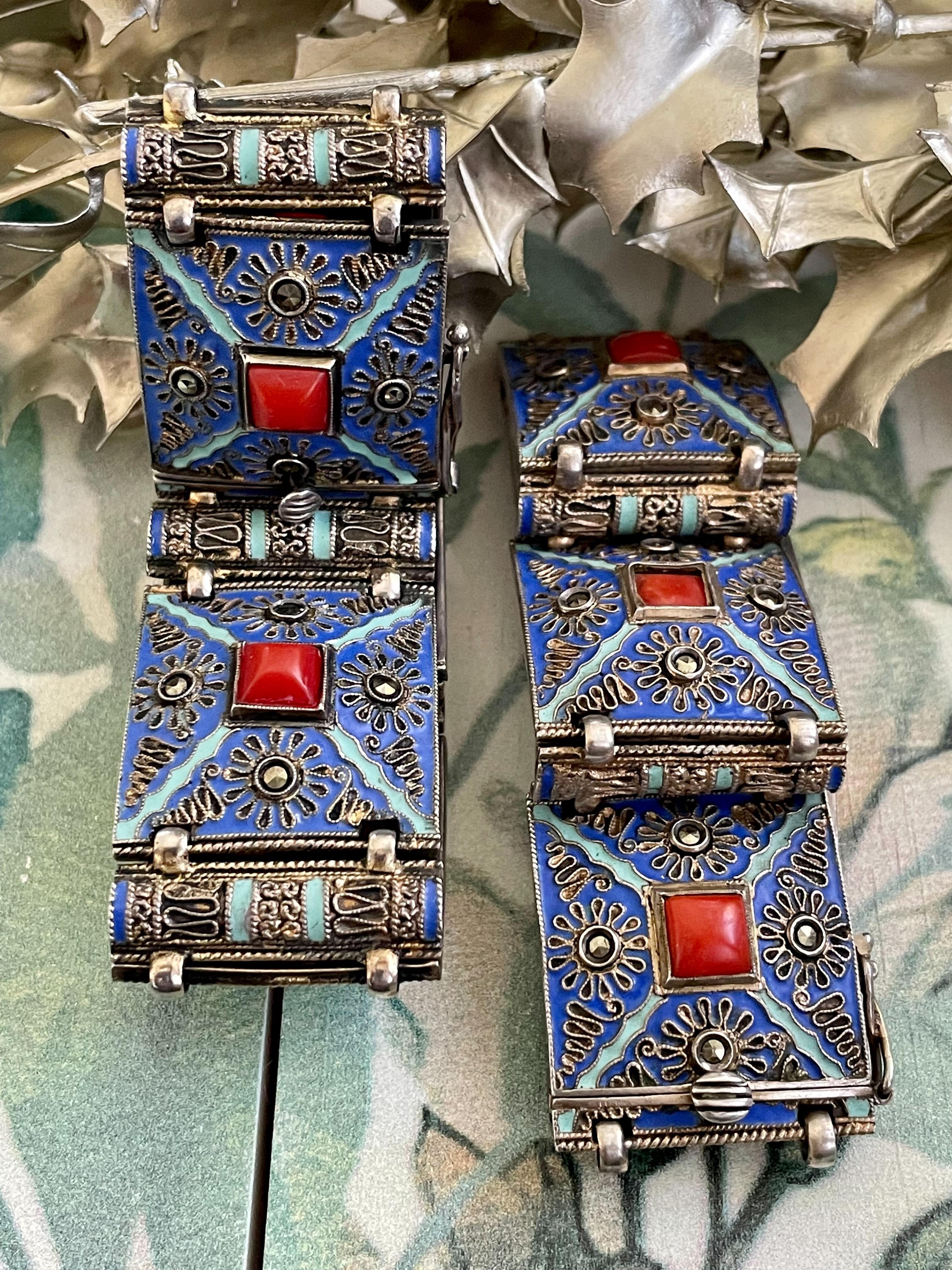These bracelets are absolutely stunning.  They are Art Deco, German made, Theodor Fahner and feature blue enamel on each link along with a square Carnelian stone, with several accents of Marcasite.

This listing is for both bracelets; we will sell