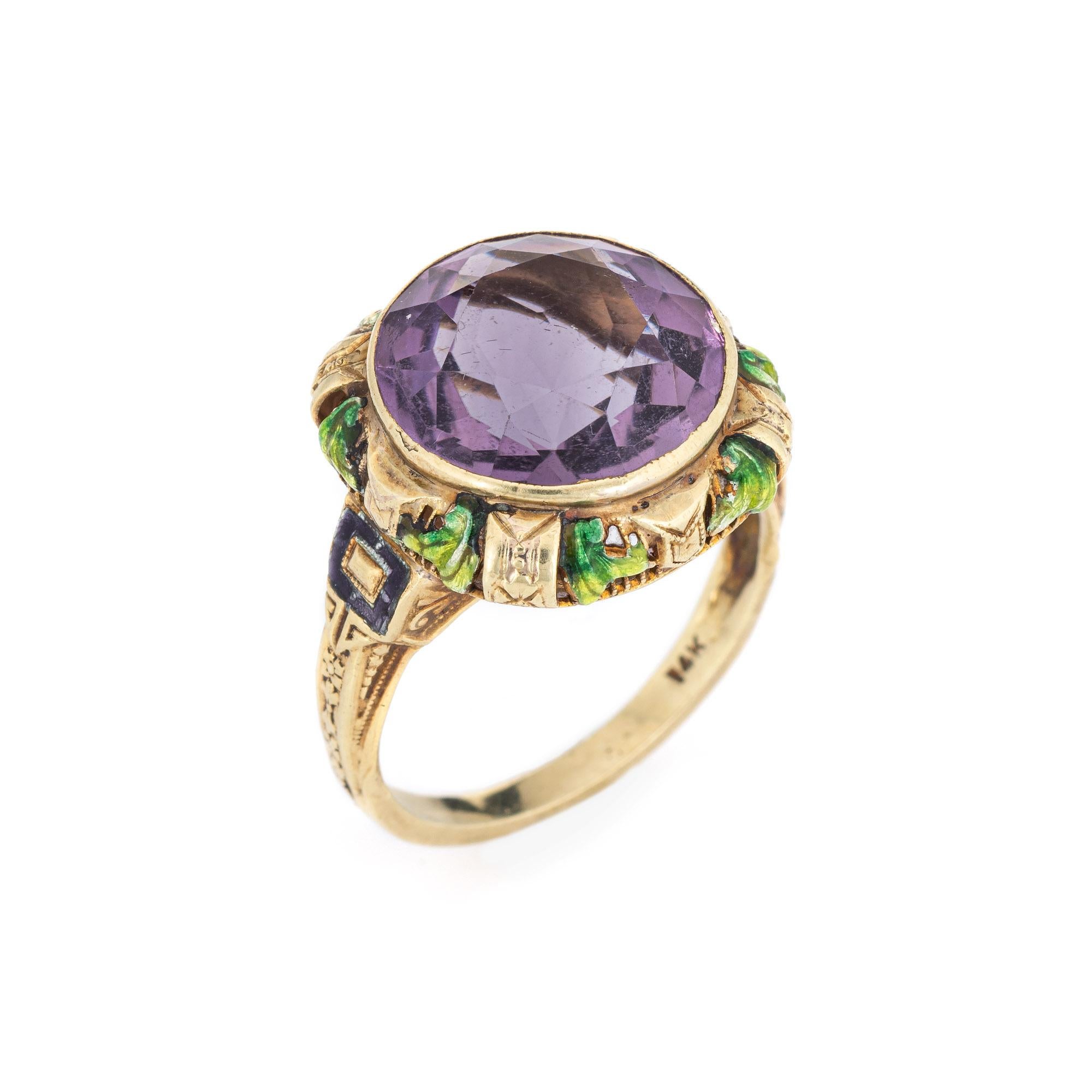 Finely detailed vintage Art Deco era amethyst enamel ring (circa 1920s to 1930s) crafted in 14k yellow gold. 

Faceted round cut amethyst is estimated at 5.50 carats. The stone shows some light abrasions visible under a 10x loupe. 

The finely