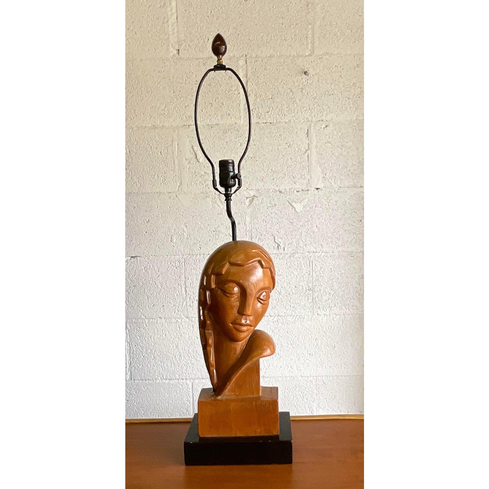 Incredible vintage hand carved female bust of an Art Deco table lamp. A beautiful stylized woman of the era that rests on a painted black plinth. Acquired from a Palm Beach estate