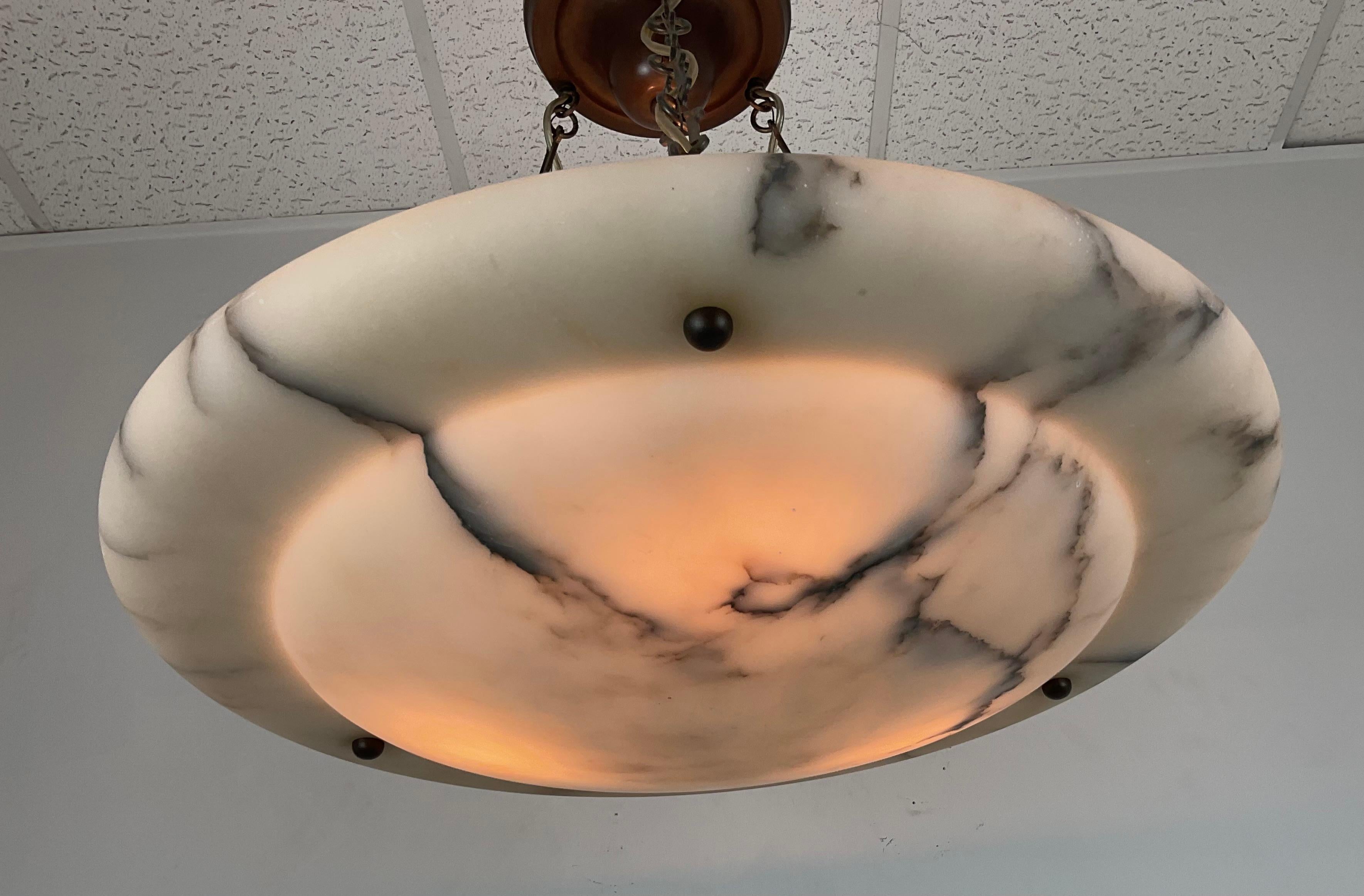 Large Natural Alabaster heavily veined art deco bowl chandelier. Gorgeous shape and simple elegant style. Bronze chains with original bronze ceiling canopy. Newly rewired with three American candelabra sockets. Comes ready to install with all