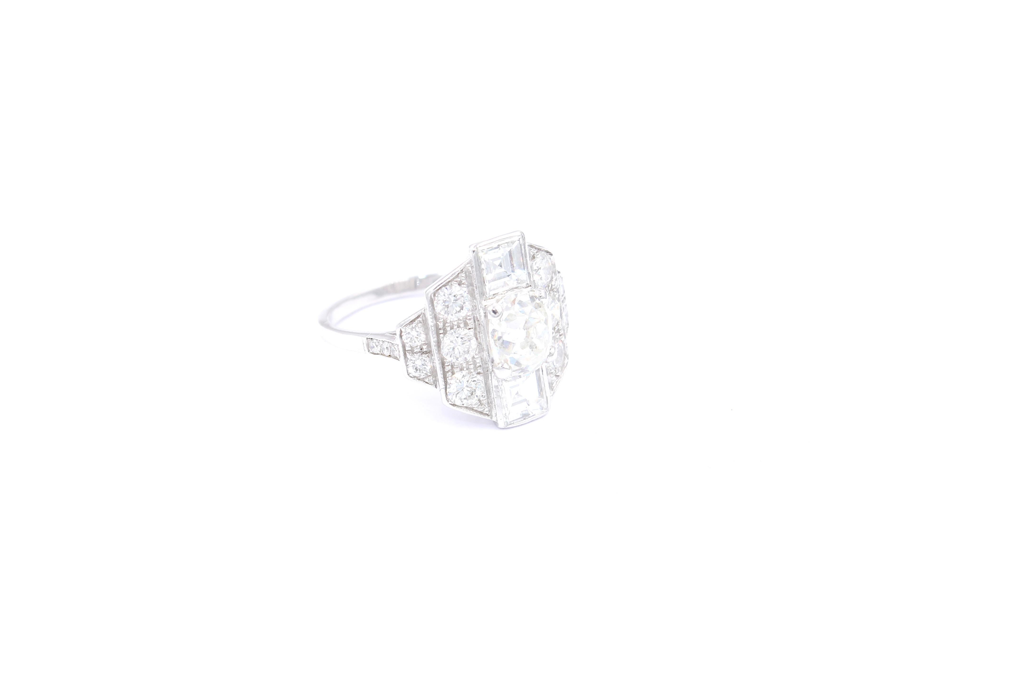 Vintage 18 Karat white gold Art Deco inspired ring. 

Ring set with a center old mine diamond of approximately 1.35 Carats (estimated H/I color - Vs2 clarity), two squared sape diamonds for a total of approximately 1.00 Carat (estimated G/H color -