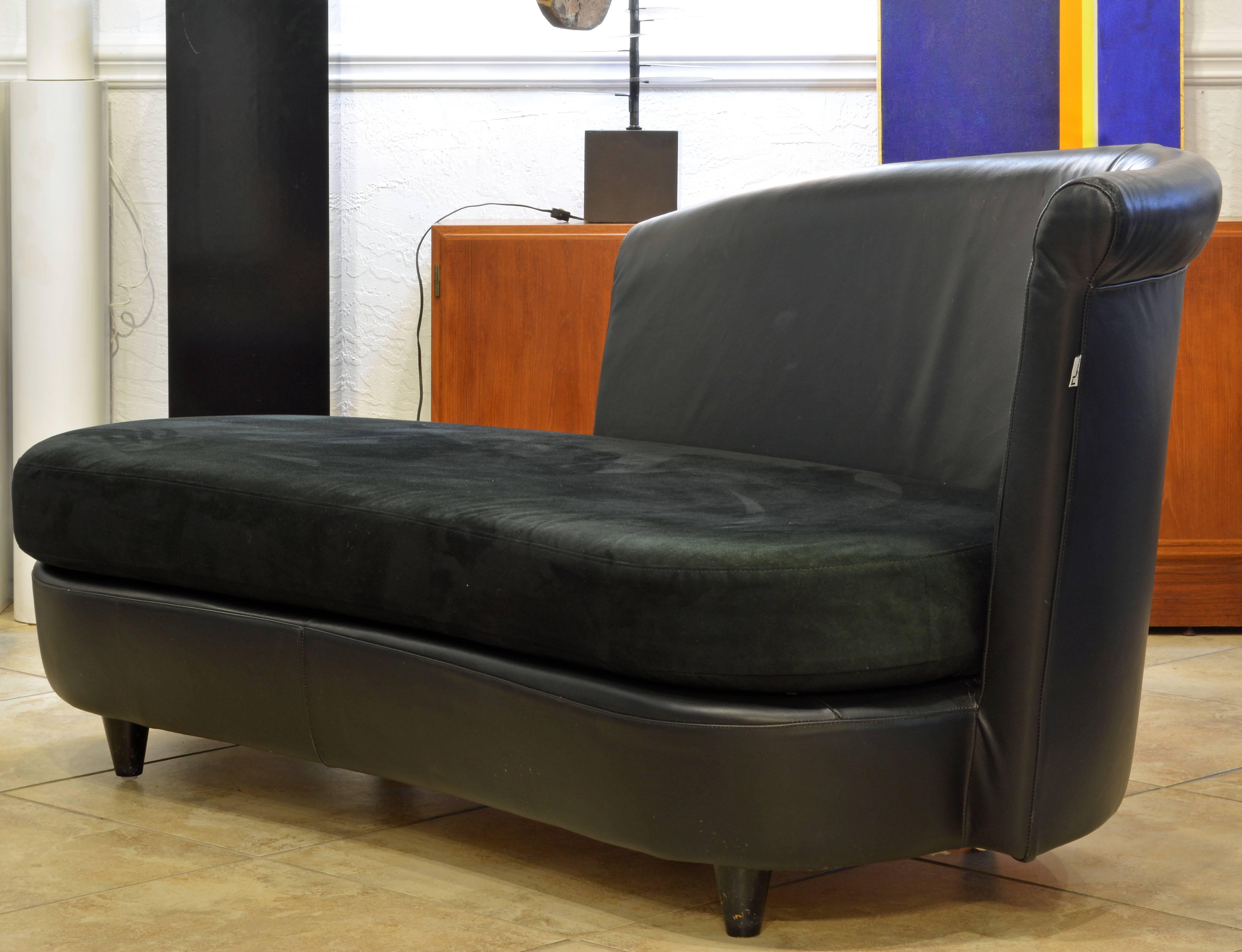 This sofa is an early example of Ferlea's change of style in the 1980s under the direction of Milvo Benini. It is inspired by the Art Deco style. The back and the base are covered in black leather and the cushion in a black suede like material