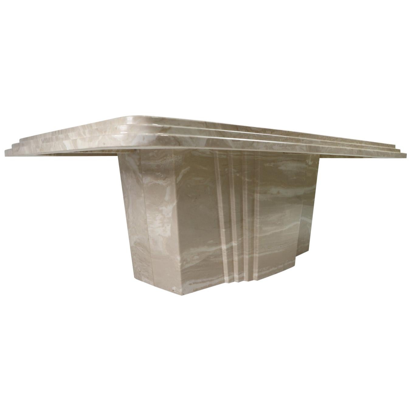 Outstanding vintage 1970s Art Deco coffee table. The monumental coffee table is made of Italian travertine. The stone closely resembles marble but has an earthy gray/beige tone. The tabletop features a triple beveled edge and rounded corners. The
