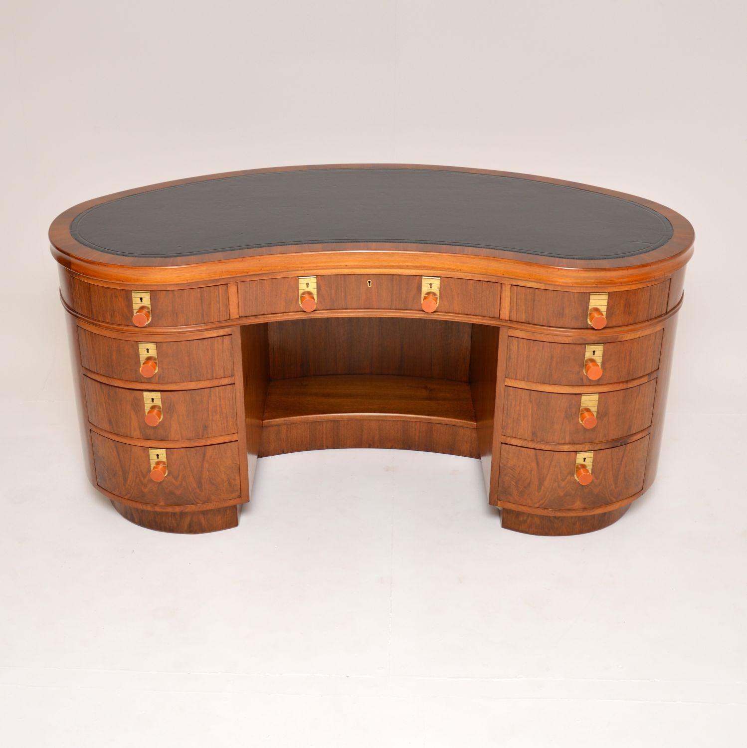 An exceptional and very rare vintage Art Deco desk in walnut, this was made in London by Laszlo Hoenig. It dates from the 1930-50’s.

The quality is outstanding, this is extremely well made and is a most impressive piece. It has a kidney shaped