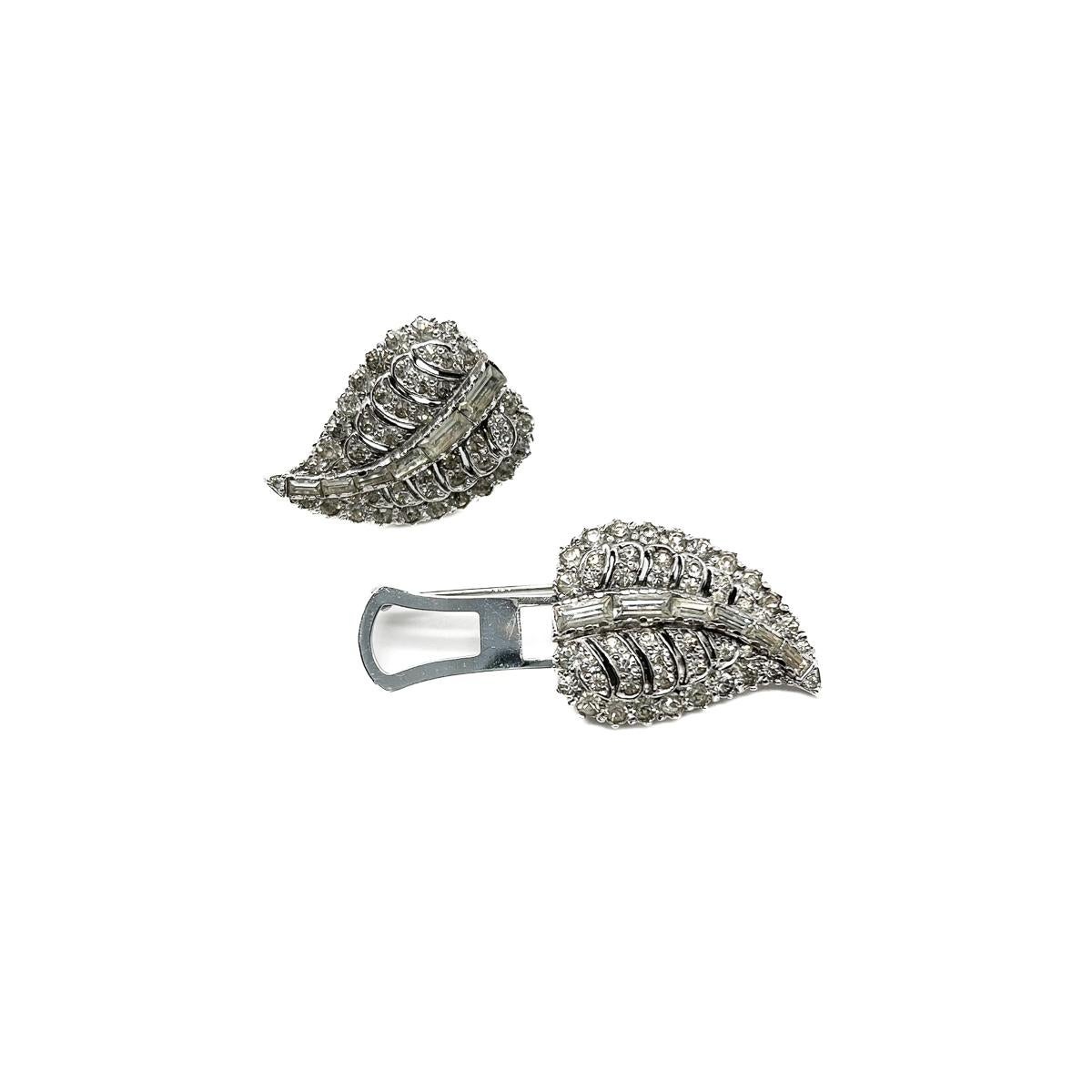 A beautiful vintage leaf double dress clip. Wear as a brooch or as a pair of dress clips. An effortlessly stylish work of Art Deco craftmanship.
During the 1920s & 30s the Art Deco style reigned supreme. The bold new look directed fashions,
