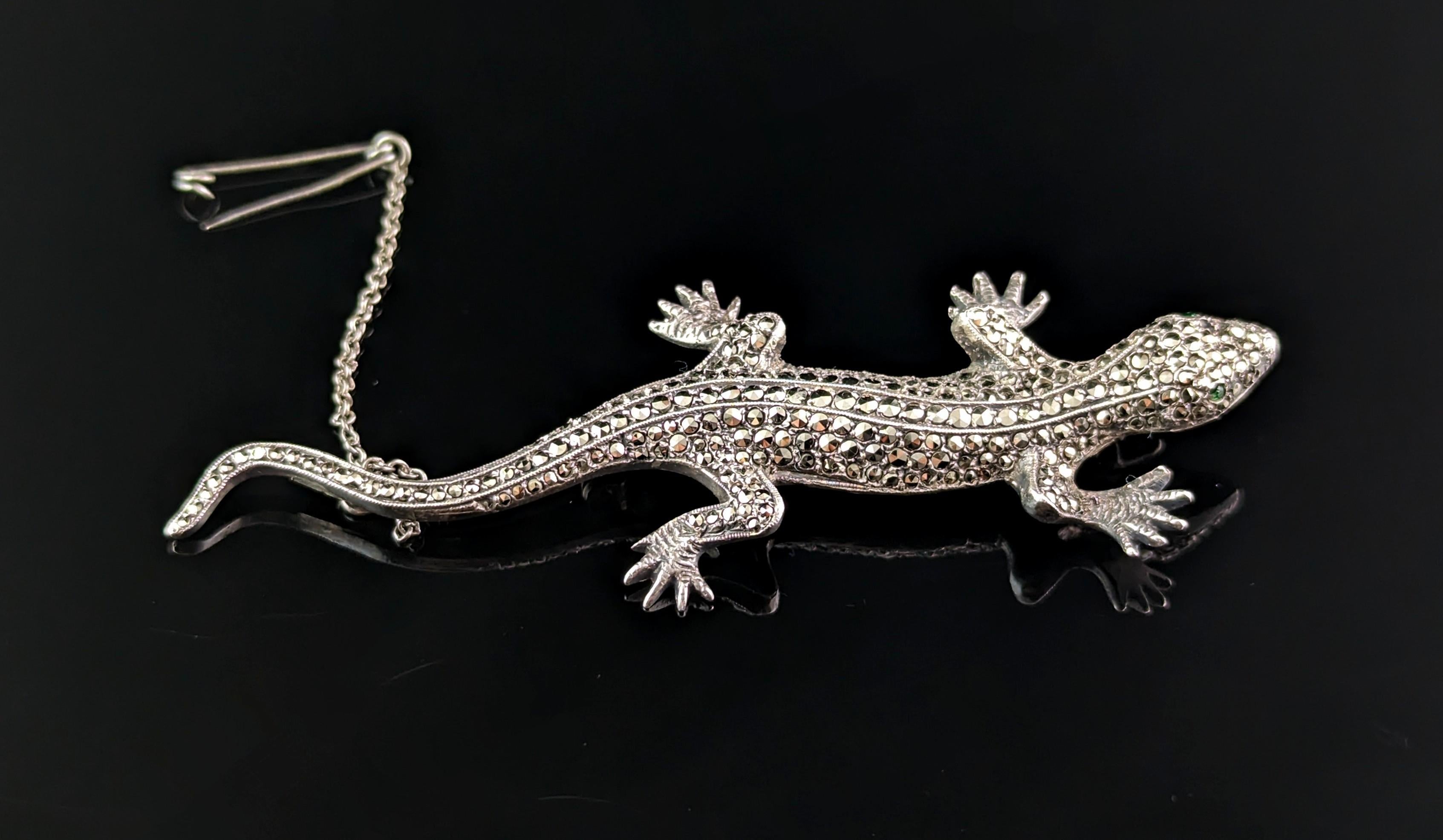 A charming Art Deco era c1930s silver and marcasite lizard brooch.

This is a large brooch well modelled as a lizard in 800 silver, adorned with marcasite and he has the sweetest little emerald green paste eyes.

Such a gorgeous vintage brooch, very