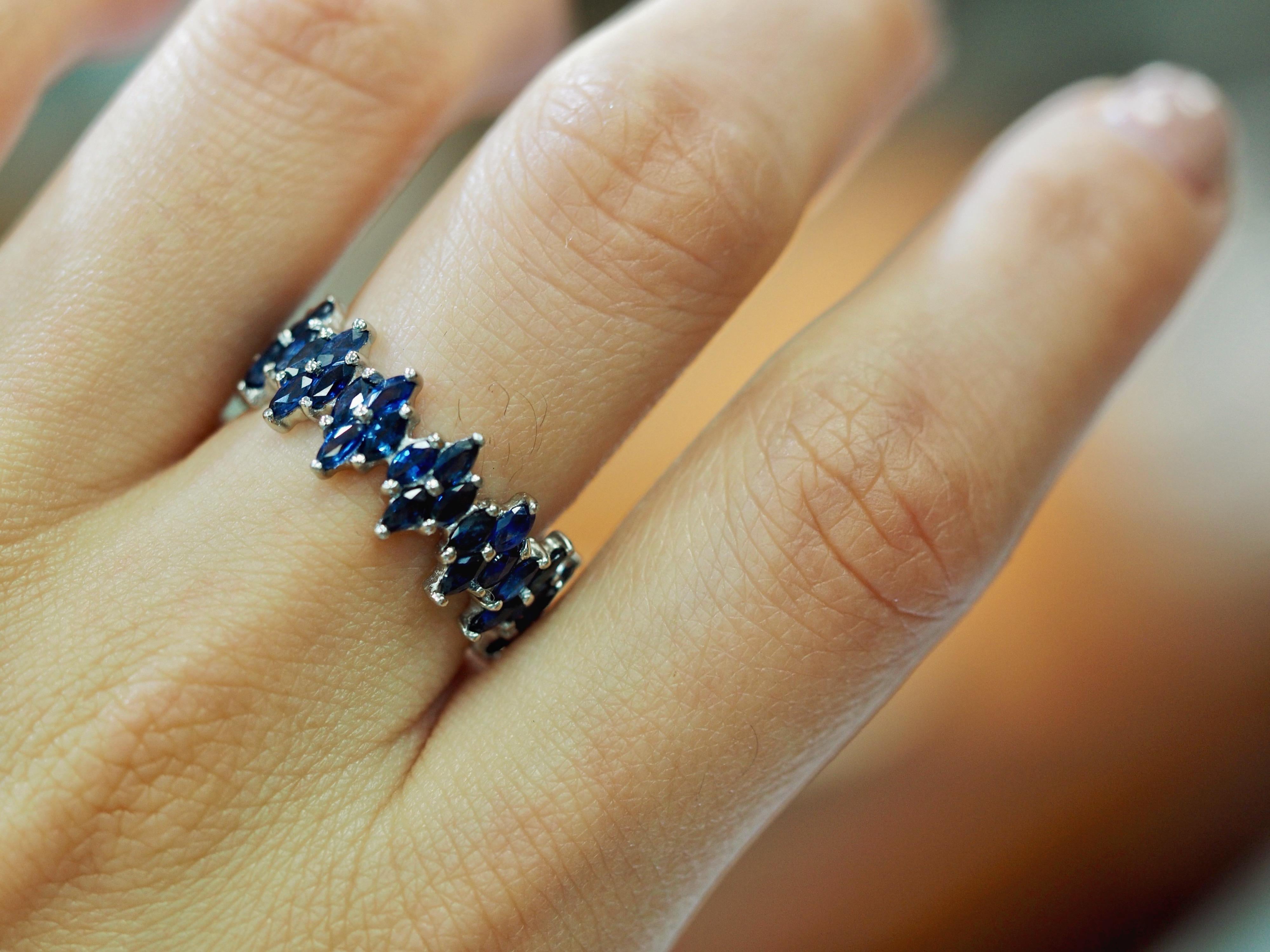 Here we have a vintage Art Deco marquise sapphire eternity band! The shimmering sapphire clusters are set together like little starbursts of color all around the stunning platinum band. This is a fun piece all on its own, but pairs wonderfully with