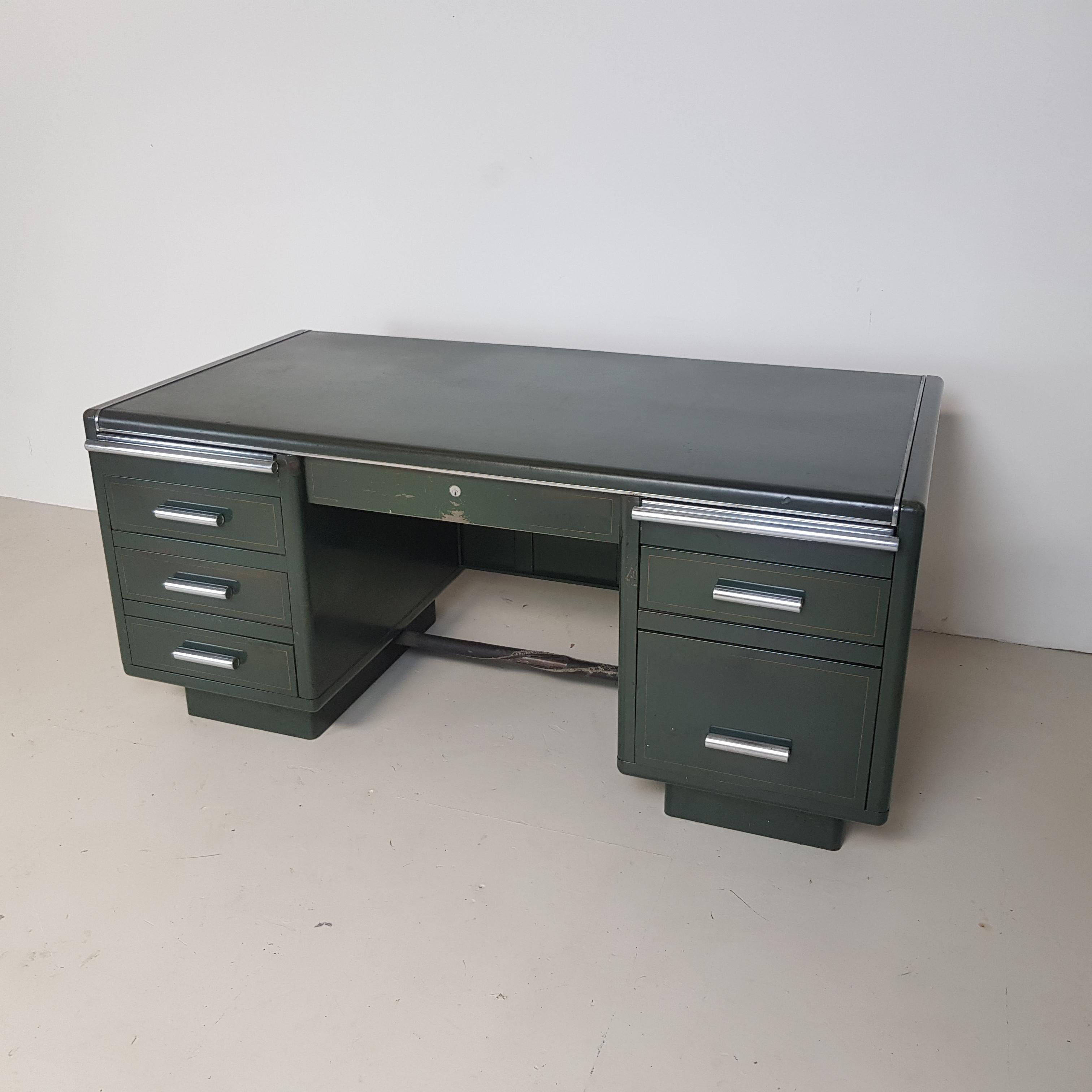 Lovely vintage double pedestal partners steel desk. This desk can be used from both sides. Drawers on one side and cupboards on the other. In its original dark green paintwork.

In good vintage condition - this piece comes from a working