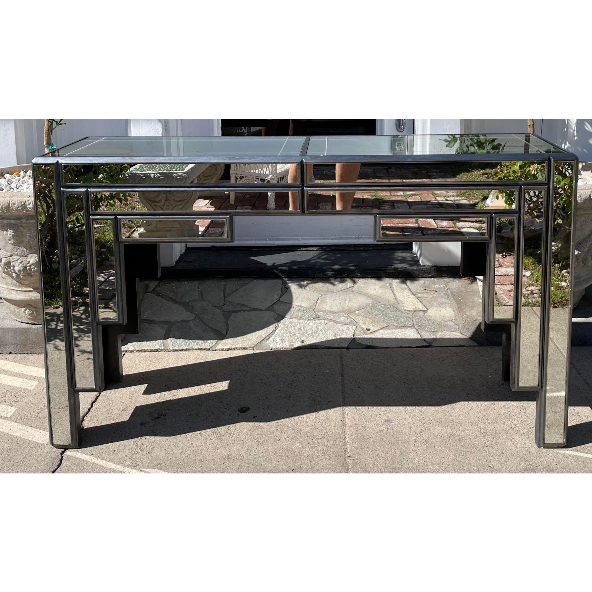 Vintage Art Deco theater mirrored console table.

Additional information: 
Materials: Mirror.
Color: Silver.
Period: Mid-20th century.
Styles: Art Deco.
Table Shape: Rectangle.
Item Type: Vintage, Antique or Pre-owned.
Dimensions: 53.5