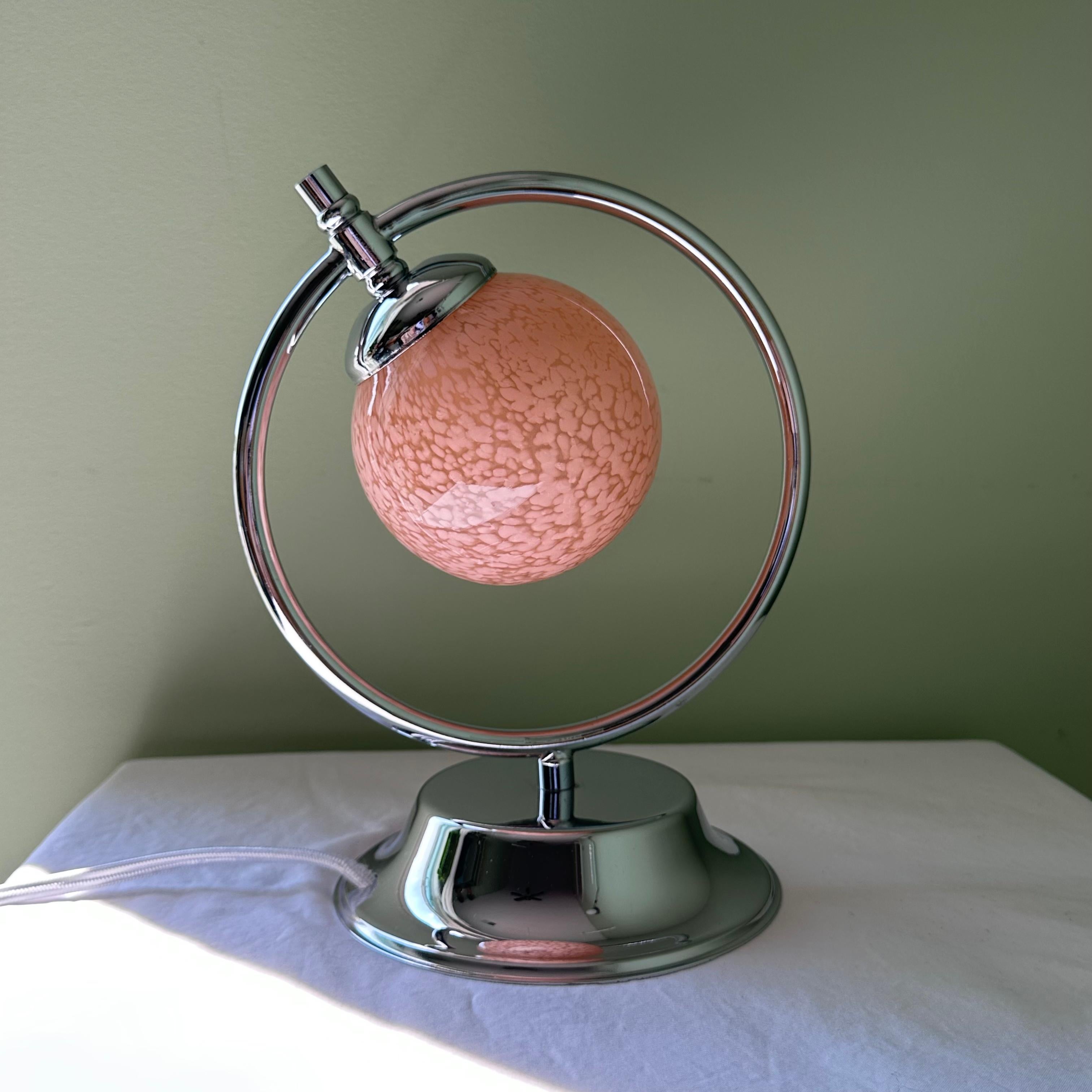 Absolutely stunning vintage Art Deco Modernist style chrome and pink glass table lamp. Petite and round, this 