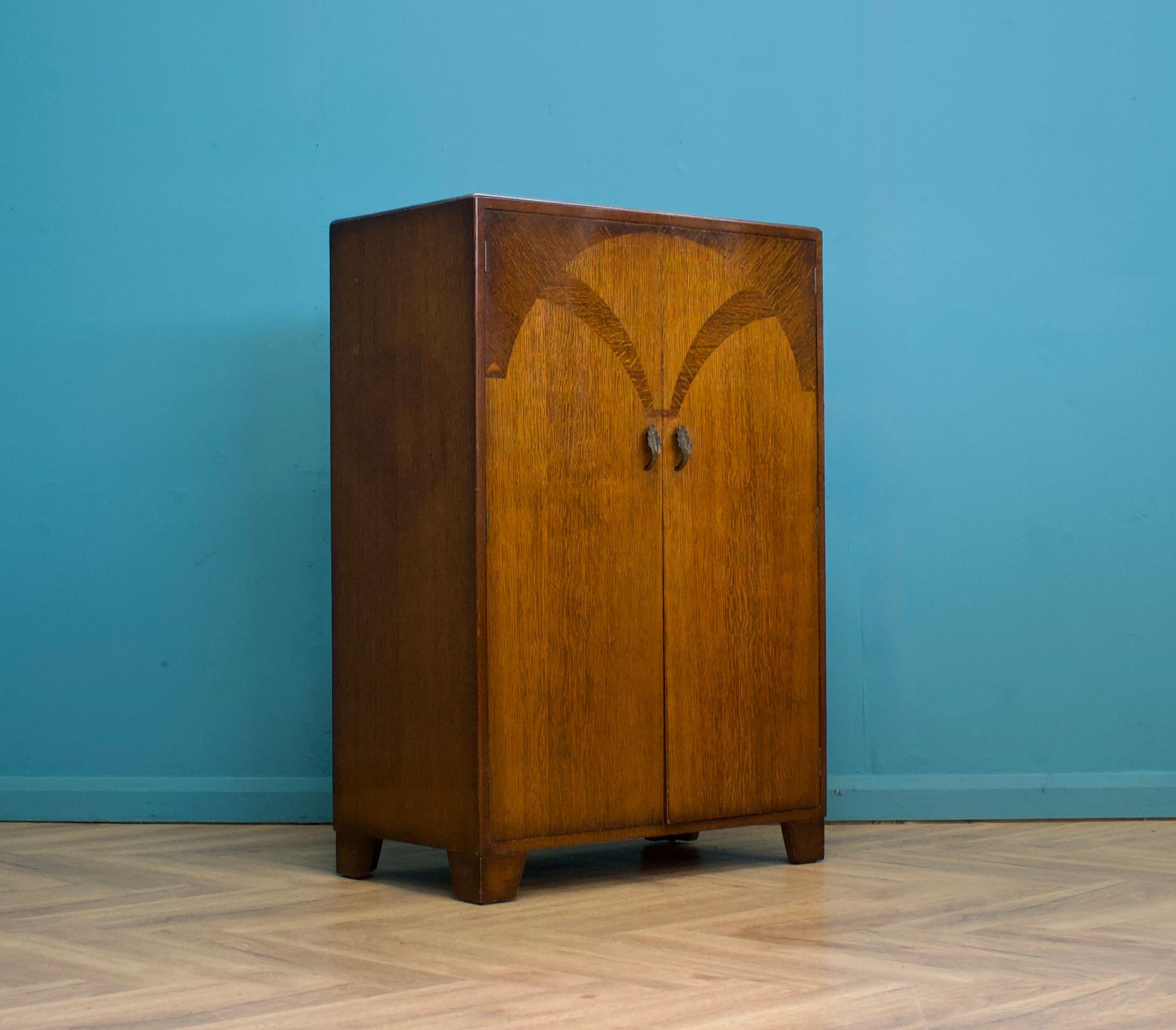 A quality vintage oak compact wardrobe
Circa 1930s


Inside is fitted out with a hanging rail and shelves
 