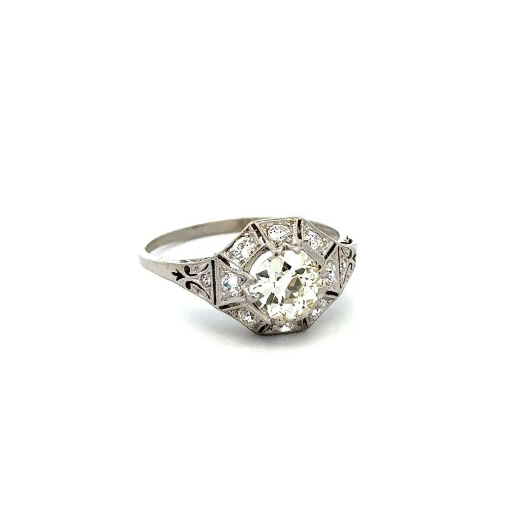 Simply Beautiful! Finely detailed Vintage Art Deco Diamond Solitaire Ring. Centering a Hand set securely nestled 0.90 Carat Old European Cut Diamond. Surrounded by Round Old European Cut Diamonds, weighing approx. 0.45tcw. Hand crafted 18K White