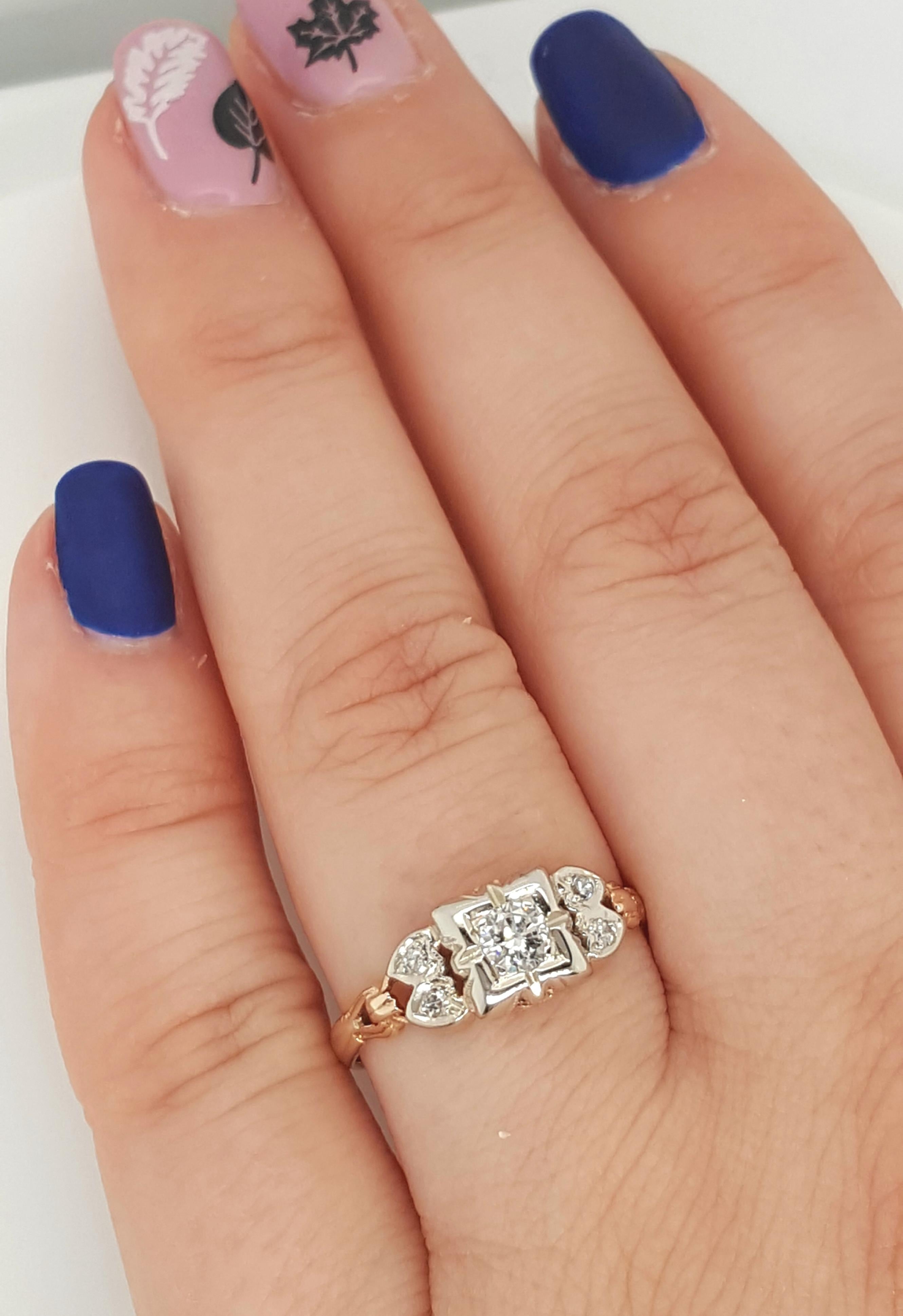 This fine example of Art Deco style is crafted in Two tone Gold with smaller diamond accents highlighting the stunning solitaire. The brilliant center Old European cut diamond is just under a half carat, top quality colorless 