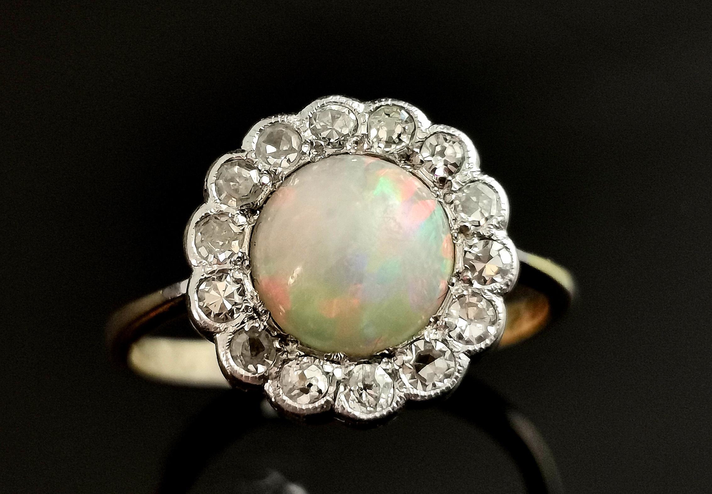 An absolutely gorgeous vintage, Art Deco era opal and diamond cluster ring.

A rich 18ct yellow gold band with a cluster style setting in cool platinum.

The face is set with a beautiful opal cabochon with a white body and a beautiful play of colour