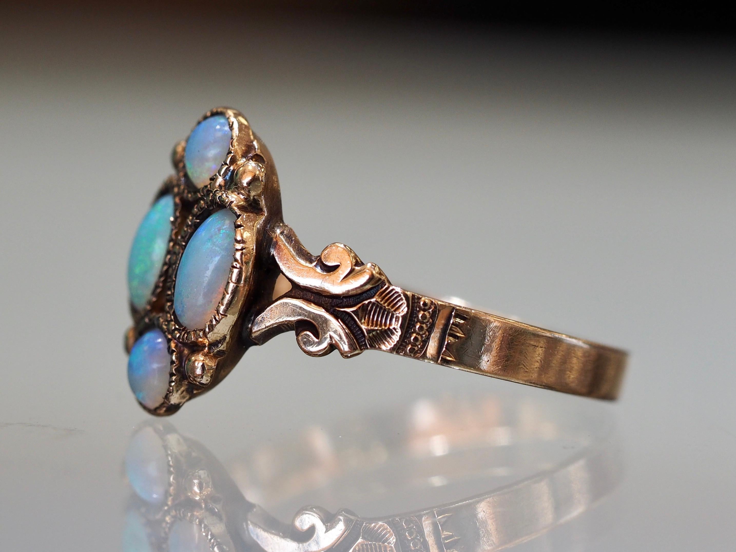This vintage Art Deco Opal Ring is the perfect vintage everyday wear. It includes four beautiful Australian opals approximately 0.44 carats with a brilliant ray of colors at every angle. The detailing on the sides is in excellent condition and you