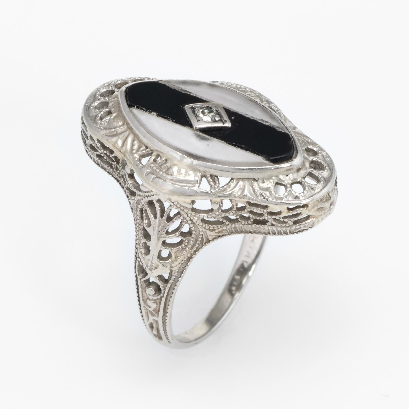Finely detailed Art Deco era ring (circa 1920s to 1930s), crafted in 14 karat white gold.

The ring is made by Ostby & Barton, one of the most well known jewelry manufacturers of the period. The firm was founded in 1879 and ceased production around