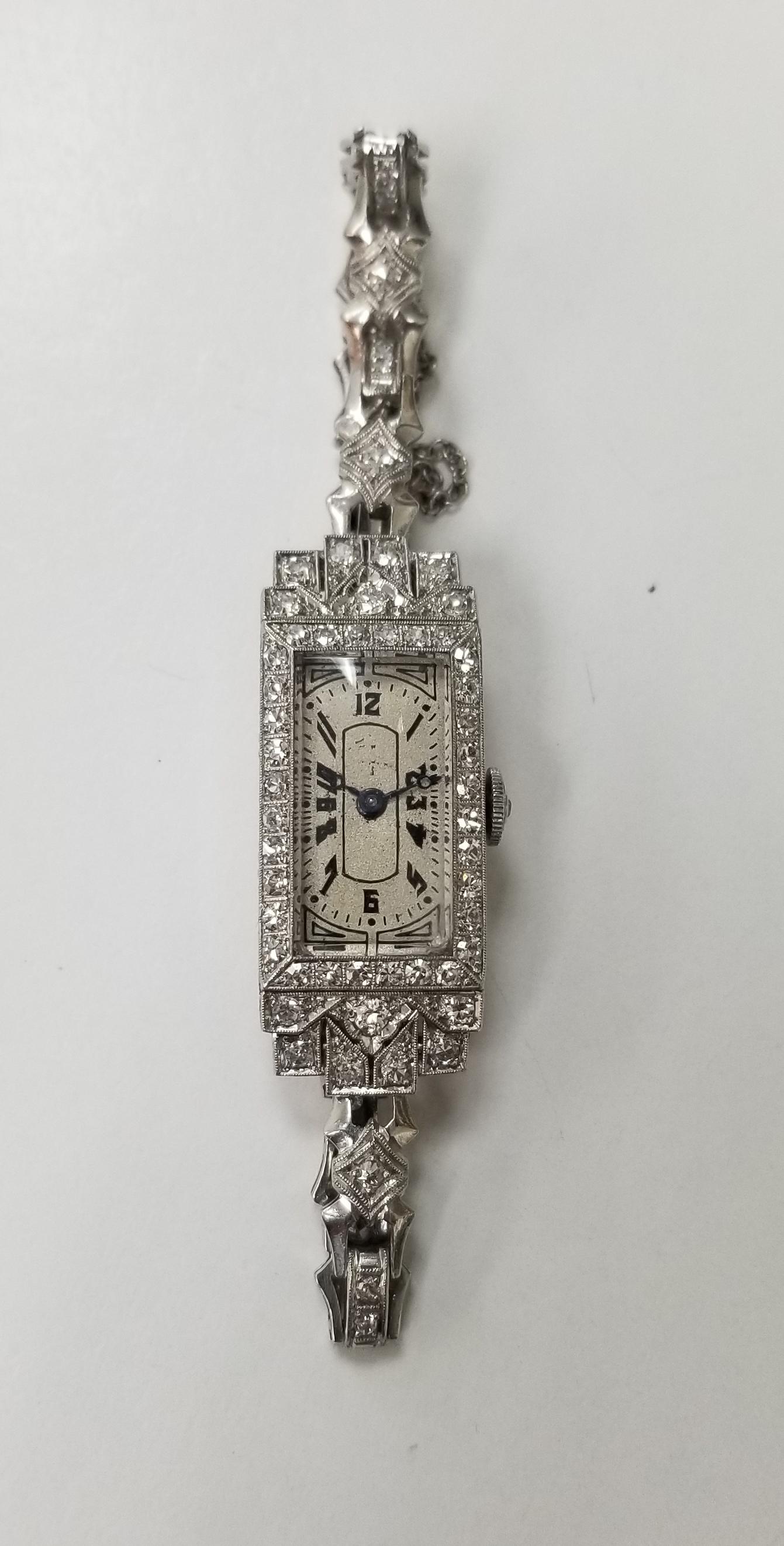 Vintage Art Deco Palladium diamond watch, containing 65 round single cut diamonds of very fine quality weighing approximately 1.50cts.  The watch is engraved from 1919.
Length is 6 1/4 inches with a safety chain