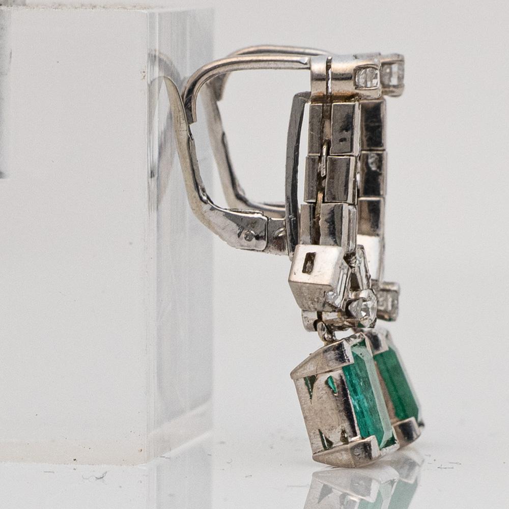 Here is a beautiful set of Vintage Art Deco Palladium Emerald and Diamond Earrings.

These earrings each feature a 0.82ct emerald cut emerald measuring approx. 7.50mm x 5.50mm x 2.72mm. Each emerald is heavily included with medium tone, slight