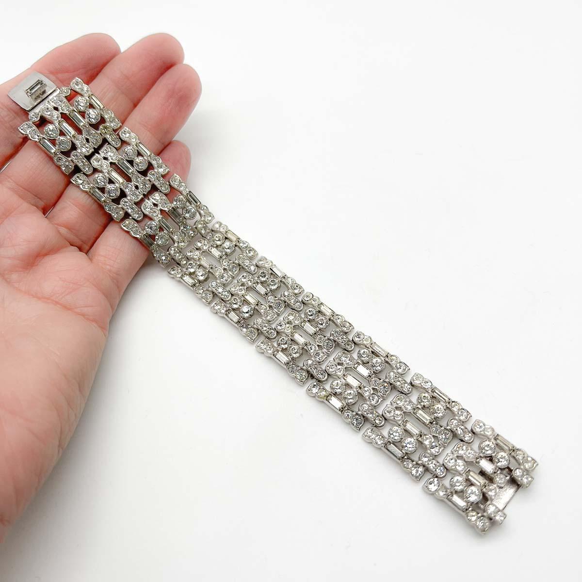 A divine original Vintage Deco cocktail bracelet, very nearly an antique. Think art deco bars, cocktails and dancing the evening away. The tank track style design is crafted to perfection in high quality rhodium plated metal, beautifully set with
