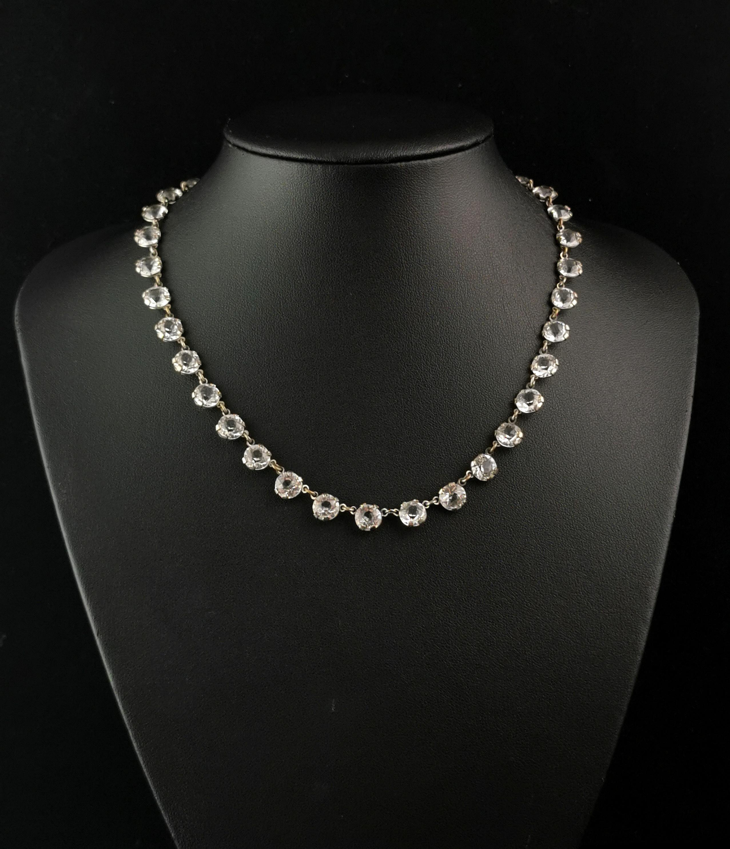 A gorgeous vintage Art Deco paste riviere necklace.

This necklace is crafted in cool toned silver plate and brings a timeless elegance to your wardrobe.

Crafted in the 1930s, it features round cut sparkling paste stones with all the shimmer of