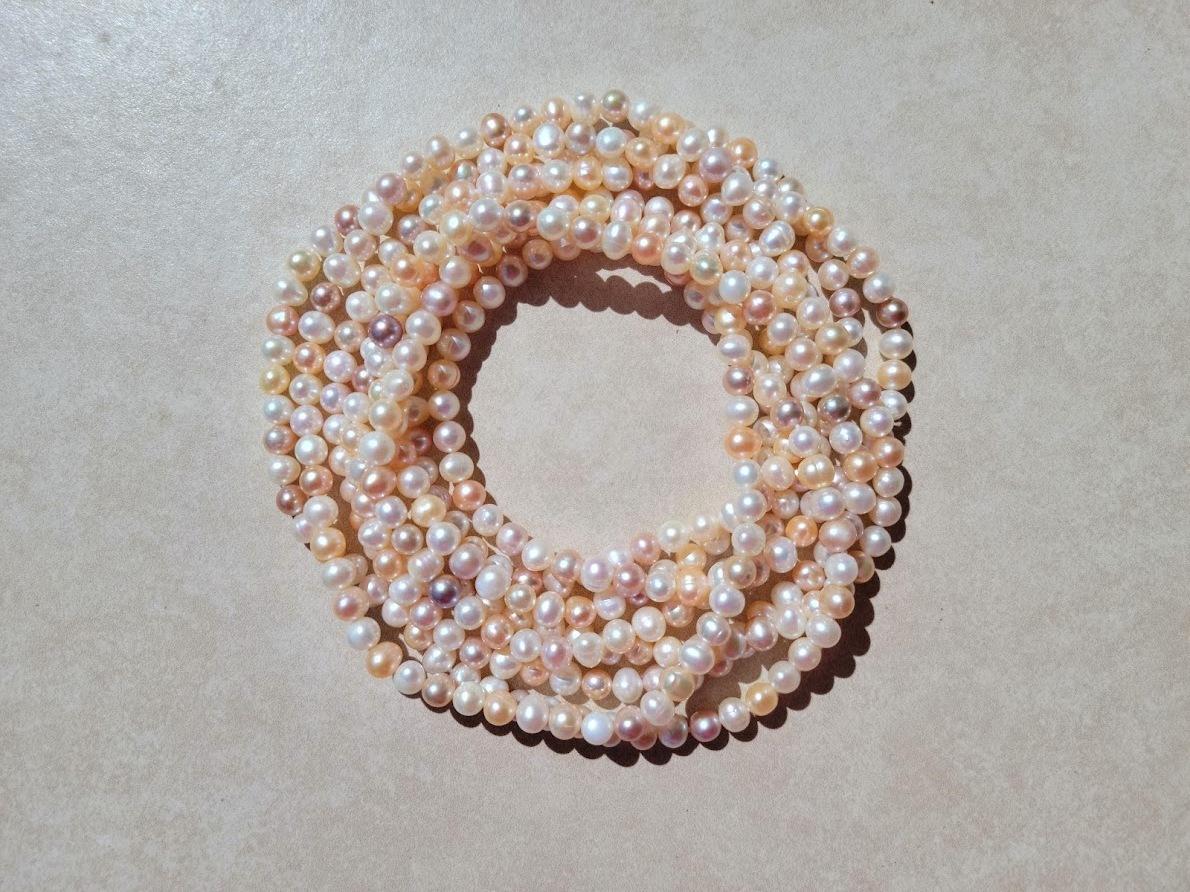 This is a cream-peach natural pearl necklace that is long at approximately 100″ from end to end – long beautiful, and elegant. There is no clasp on this necklace as it is one extra long continual strand, or you can wear it with multiple strands.
