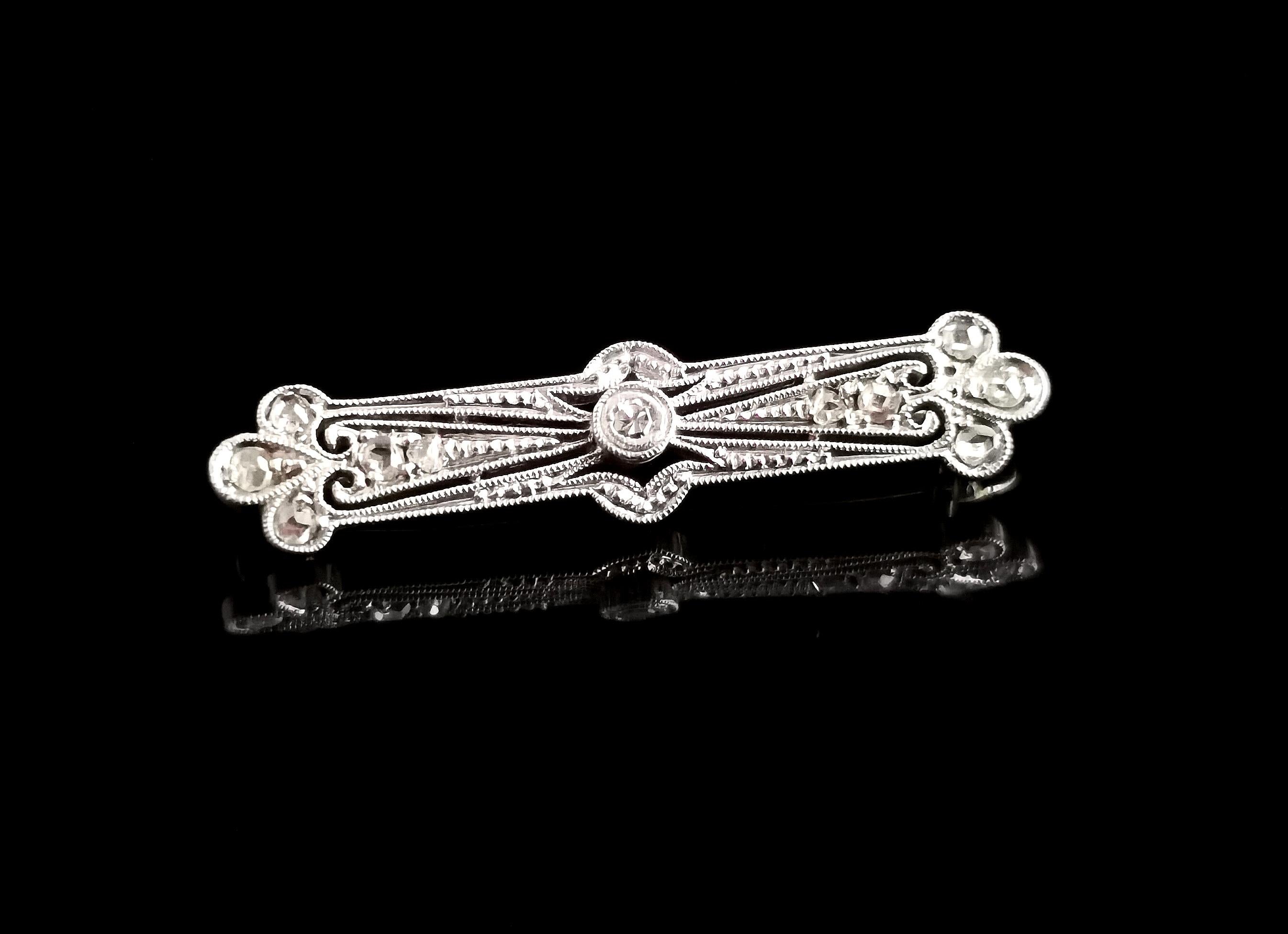 A magnificent vintage Art Deco platinum and diamond brooch.

A beautifully designed piece with the greatest attention to detail, well crafted in the Art Deco manner with openwork and scrolling features, it is a bar type brooch with trefoil shaped