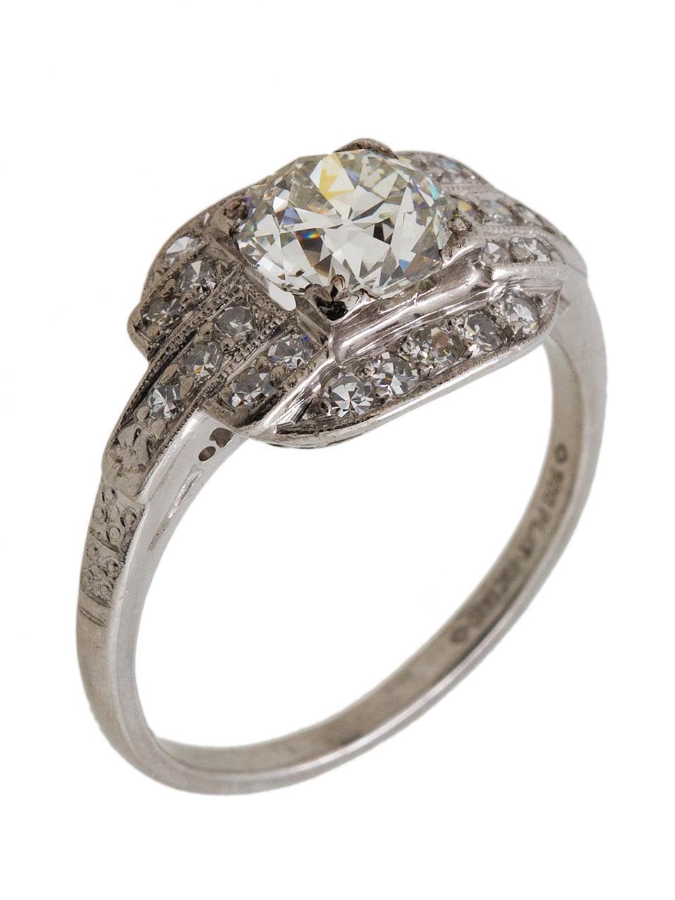 Striking Art Deco platinum engagement ring featuring an incredibly bright and well proportioned Old European Cut center diamond, weighing approximately .70ct, H-VS2. In addition to the center stone there are five rows of bead set single-cut side